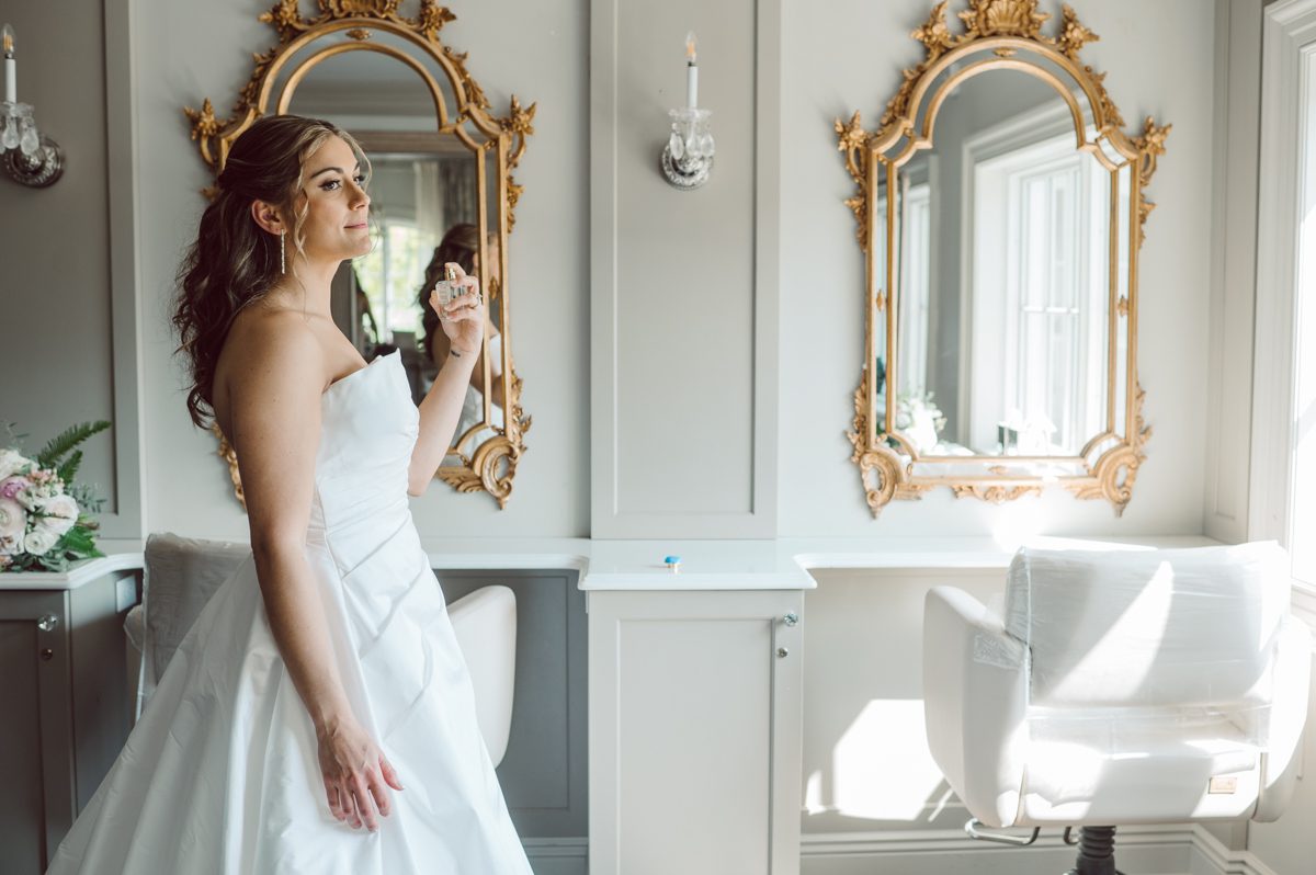 It literally felt like 1000 degrees on Faith and Joe’s wedding at Park Chateau Estate and Gardens. Sun was out and had no plan to hide, not a single cloud in the sky. Despite the gorgeous gardens at Park Chateau Faith and Joe decide to stay cool and alive indoors. I totally don’t blame them, I would much rather be indoor with AC. Thankfully the bridal and groom’s suite at Park Chateau Estate and Gardens is very photogenic with lots of windows. I fully utilized the bridal suite for faith’s getting ready, formal photos with her bridesmaids, first look with her father and her solo photos all before the ceremony. Ceremony was held at the chapel onsite at Park Chateau making everything easy. After the ceremony Faith and Joe did quick few photos outside, some family and group photos then quickly ran indoors before they melted onto the beautiful gardens of Park Chateau. The reception room was filled with peonies and cherry branches it was gorgeous, perfect HOT spring wedding decor. Faith and Joe enjoyed their wedding day the way they wanted by eating drinking and dancing mingling with their guests inside under Cool AC. Faith and Joe’s Park Chateau Estate and Gardens Wedding captured by Karis from Hey Karis NY, NJ, Brooklyn, Hudson Valley and Catskills Wedding and Elopement Photographer.