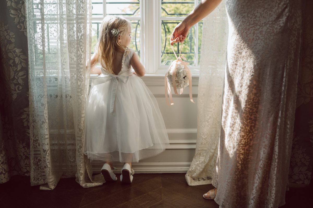 It literally felt like 1000 degrees on Faith and Joe’s wedding at Park Chateau Estate and Gardens. Sun was out and had no plan to hide, not a single cloud in the sky. Despite the gorgeous gardens at Park Chateau Faith and Joe decide to stay cool and alive indoors. I totally don’t blame them, I would much rather be indoor with AC. Thankfully the bridal and groom’s suite at Park Chateau Estate and Gardens is very photogenic with lots of windows. I fully utilized the bridal suite for faith’s getting ready, formal photos with her bridesmaids, first look with her father and her solo photos all before the ceremony. Ceremony was held at the chapel onsite at Park Chateau making everything easy. After the ceremony Faith and Joe did quick few photos outside, some family and group photos then quickly ran indoors before they melted onto the beautiful gardens of Park Chateau. The reception room was filled with peonies and cherry branches it was gorgeous, perfect HOT spring wedding decor. Faith and Joe enjoyed their wedding day the way they wanted by eating drinking and dancing mingling with their guests inside under Cool AC. Faith and Joe’s Park Chateau Estate and Gardens Wedding captured by Karis from Hey Karis NY, NJ, Brooklyn, Hudson Valley and Catskills Wedding and Elopement Photographer.