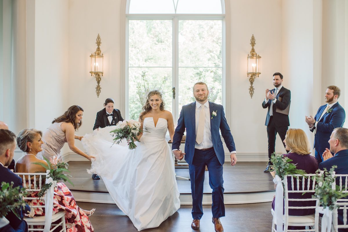 It literally felt like 1000 degrees on Faith and Joe’s wedding at Park Chateau Estate and Gardens. Sun was out and had no plan to hide, not a single cloud in the sky. Despite the gorgeous gardens at Park Chateau Faith and Joe decide to stay cool and alive indoors. I totally don’t blame them, I would much rather be indoor with AC. Thankfully the bridal and groom’s suite at Park Chateau Estate and Gardens is very photogenic with lots of windows. I fully utilized the bridal suite for faith’s getting ready, formal photos with her bridesmaids, first look with her father and her solo photos all before the ceremony. Ceremony was held at the chapel onsite at Park Chateau making everything easy. After the ceremony Faith and Joe did quick few photos outside, some family and group photos then quickly ran indoors before they melted onto the beautiful gardens of Park Chateau. The reception room was filled with peonies and cherry branches it was gorgeous, perfect HOT spring wedding decor. Faith and Joe enjoyed their wedding day the way they wanted by eating drinking and dancing mingling with their guests inside under Cool AC. Faith and Joe’s Park Chateau Estate and Gardens Wedding captured by Karis from Hey Karis NY, NJ, Brooklyn, Hudson Valley and Catskills Wedding and Elopement Photographer.