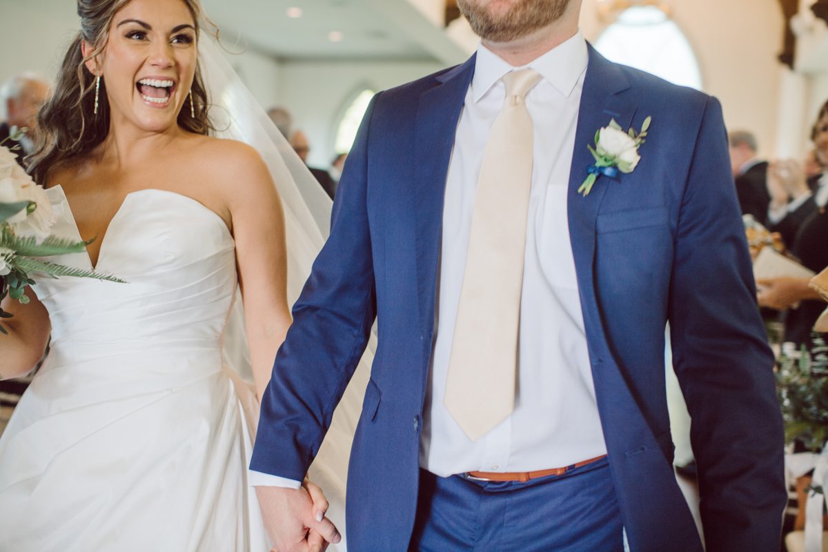 It literally felt like 1000 degrees on Faith and Joe’s wedding at Park Chateau Estate and Gardens. Sun was out and had no plan to hide, not a single cloud in the sky. Despite the gorgeous gardens at Park Chateau Faith and Joe decide to stay cool and alive indoors. I totally don’t blame them, I would much rather be indoor with AC. Thankfully the bridal and groom’s suite at Park Chateau Estate and Gardens is very photogenic with lots of windows. I fully utilized the bridal suite for faith’s getting ready, formal photos with her bridesmaids, first look with her father and her solo photos all before the ceremony. Ceremony was held at the chapel onsite at Park Chateau making everything easy. After the ceremony Faith and Joe did quick few photos outside, some family and group photos then quickly ran indoors before they melted onto the beautiful gardens of Park Chateau. The reception room was filled with peonies and cherry branches it was gorgeous, perfect HOT spring wedding decor. Faith and Joe enjoyed their wedding day the way they wanted by eating drinking and dancing mingling with their guests inside under Cool AC. Faith and Joe’s Park Chateau Estate and Gardens Wedding captured by Karis from Hey Karis NY, NJ, Brooklyn, Hudson Valley and Catskills Wedding and Elopement Photographer.