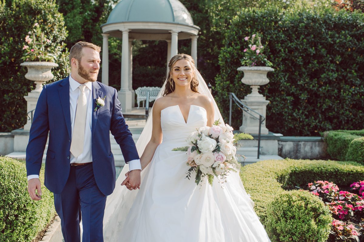 It literally felt like 1000 degrees on Faith and Joe’s wedding at Park Chateau Estate and Gardens. Sun was out and had no plan to hide, not a single cloud in the sky. Despite the gorgeous gardens at Park Chateau Faith and Joe decide to stay cool and alive indoors. I totally don’t blame them, I would much rather be indoor with AC. Thankfully the bridal and groom’s suite at Park Chateau Estate and Gardens is very photogenic with lots of windows. I fully utilized the bridal suite for faith’s getting ready, formal photos with her bridesmaids, first look with her father and her solo photos all before the ceremony. Ceremony was held at the chapel onsite at Park Chateau making everything easy. After the ceremony Faith and Joe did quick few photos outside, some family and group photos then quickly ran indoors before they melted onto the beautiful gardens of Park Chateau. The reception room was filled with peonies and cherry branches it was gorgeous, perfect HOT spring wedding decor. Faith and Joe enjoyed their wedding day the way they wanted by eating drinking and dancing mingling with their guests inside under Cool AC. Faith and Joe’s Park Chateau Estate and Gardens Wedding captured by Karis from Hey Karis NY, NJ, Brooklyn, Hudson Valley and Catskills Wedding and Elopement Photographer.