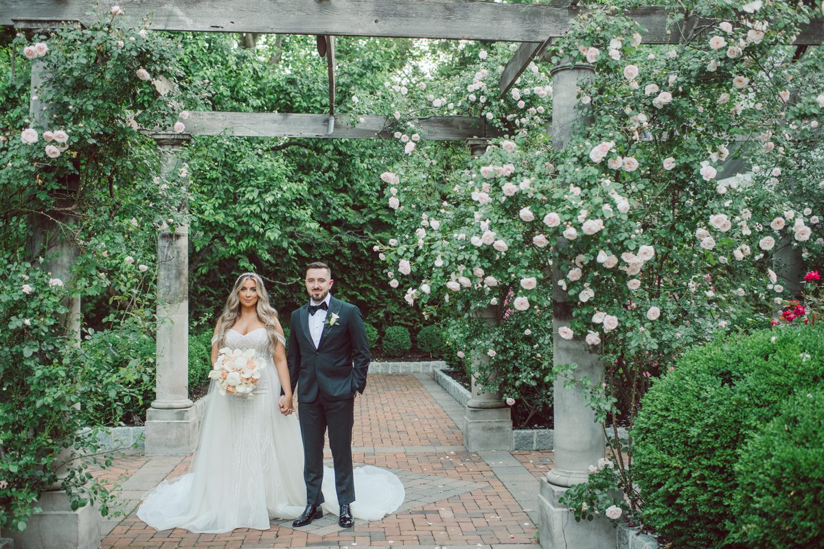 At Florentine Gardens in River Vale NJ celebrating Sam and Mike's wedding. Here at Florentine Gardens you'll get your amazing ballroom, gorgeous landscaped garden and during Sam and Mike's wedding day the roses were in full bloom it was truly beautiful. With roses in full bloom at the rose garden in Florentine Gardens, Sam and Mike's outdoor wedding ceremony was gorgeous bit hot but so gorgeous. And we were fully able to enjoy the roses during Sam and Mike's wedding portrait session. Sam and Mike's Florentine Gardens, NJ wedding captured by Karis from Hey Karis NY, NJ, Brooklyn, Hudson Valley and Catskills Wedding and Elopement Photographer.