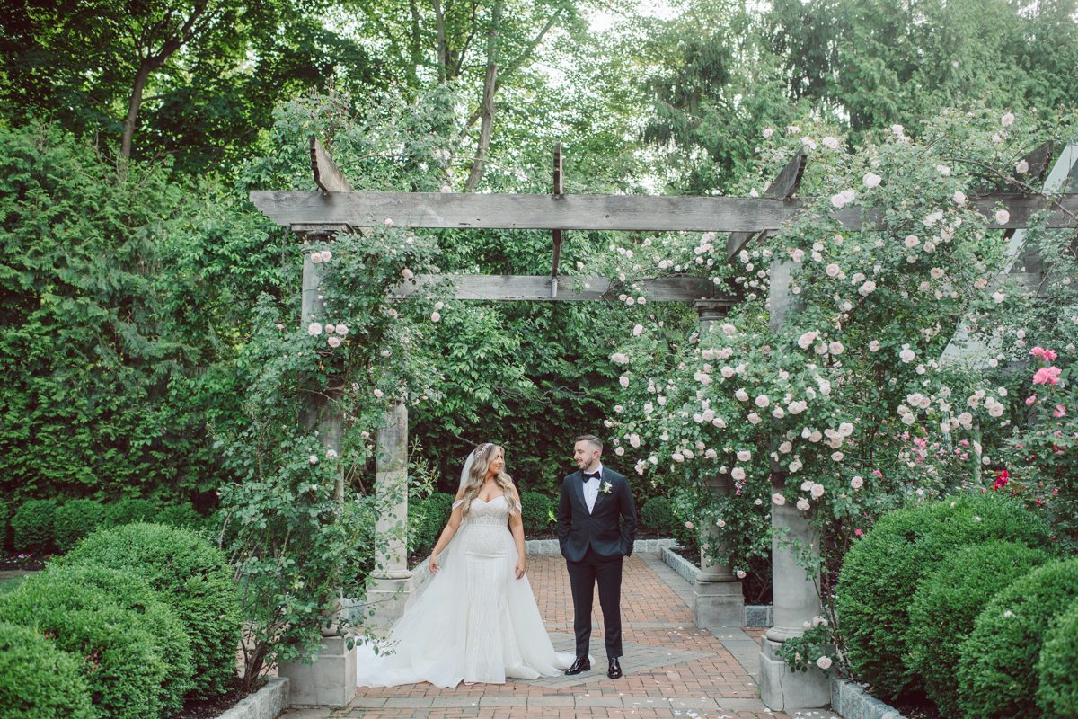 At Florentine Gardens in River Vale NJ celebrating Sam and Mike's wedding. Here at Florentine Gardens you'll get your amazing ballroom, gorgeous landscaped garden and during Sam and Mike's wedding day the roses were in full bloom it was truly beautiful. With roses in full bloom at the rose garden in Florentine Gardens, Sam and Mike's outdoor wedding ceremony was gorgeous bit hot but so gorgeous. And we were fully able to enjoy the roses during Sam and Mike's wedding portrait session. Sam and Mike's Florentine Gardens, NJ wedding captured by Karis from Hey Karis NY, NJ, Brooklyn, Hudson Valley and Catskills Wedding and Elopement Photographer.