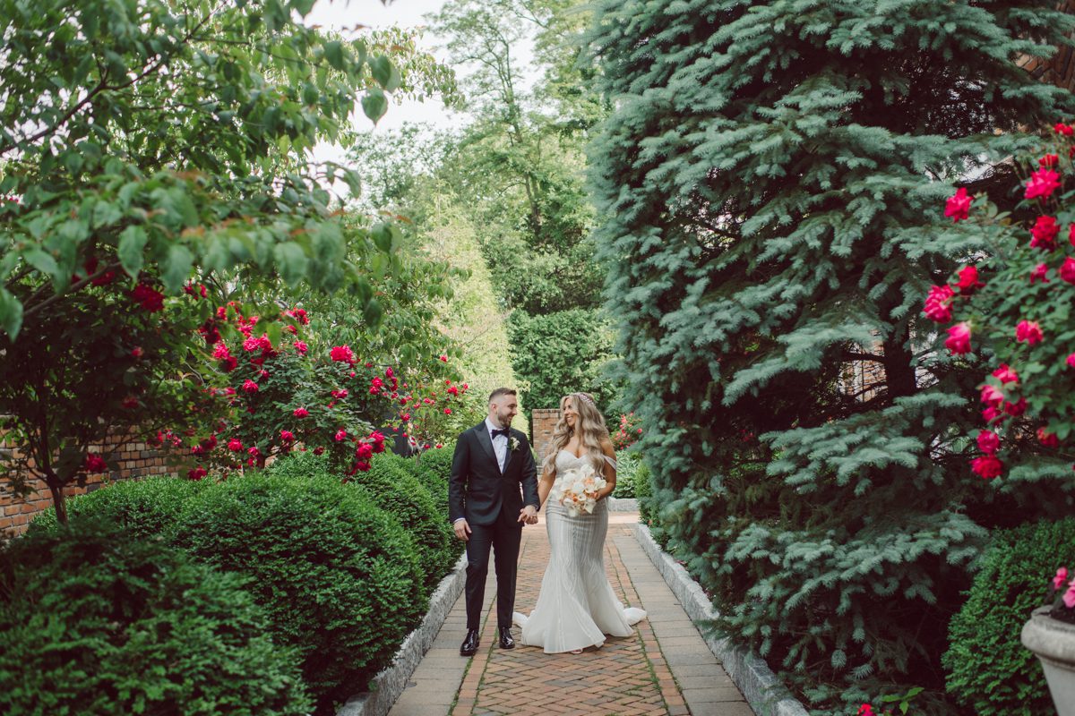 At Florentine Gardens in River Vale NJ celebrating Sam and Mike's wedding. Here at Florentine Gardens you'll get your amazing ballroom, gorgeous landscaped garden and during Sam and Mike's wedding day the roses were in full bloom it was truly beautiful. With roses in full bloom at the rose garden in Florentine Gardens, Sam and Mike's outdoor wedding ceremony was gorgeous bit hot but so gorgeous. And we were fully able to enjoy the roses during Sam and Mike's wedding portrait session. Sam and Mike's Florentine Gardens, NJ wedding captured by Karis from Hey Karis NY, NJ, Brooklyn, Hudson Valley and Catskills Wedding and Elopement Photographer.