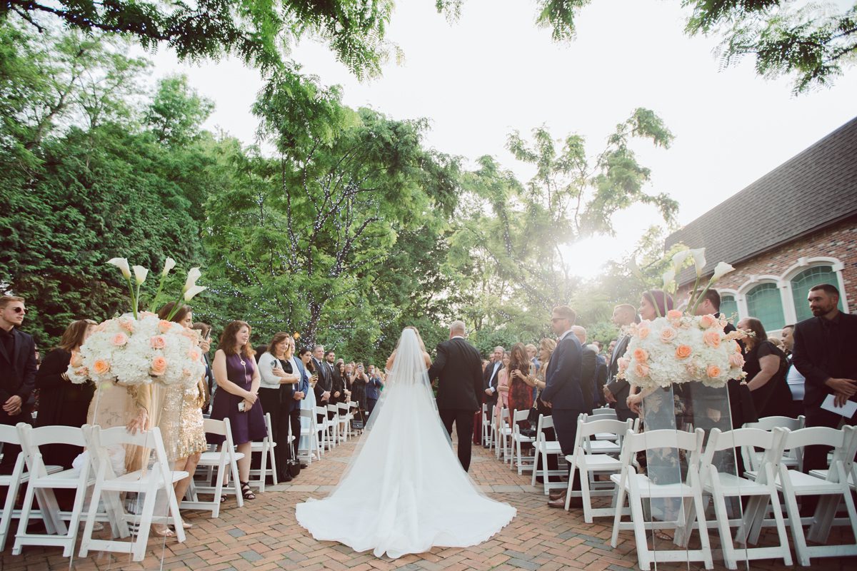 At Florentine Gardens in River Vale NJ celebrating Sam and Mike's wedding. Here at Florentine Gardens you'll get your amazing ballroom, gorgeous landscaped garden and during Sam and Mike's wedding day the roses were in full bloom it was truly beautiful. With roses in full bloom at the rose garden in Florentine Gardens, Sam and Mike's outdoor wedding ceremony was gorgeous bit hot but so gorgeous. And we were fully able to enjoy the roses during Sam and Mike's wedding portrait session. Sam and Mike's Florentine Gardens, NJ wedding captured by Karis from Hey Karis NY, NJ, Brooklyn, Hudson Valley and Catskills Wedding and Elopement Photographer.