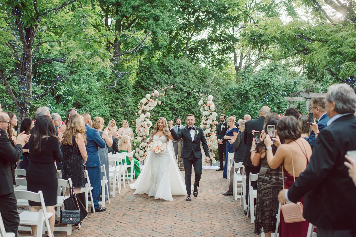 At Florentine Gardens in River Vale NJ celebrating Sam and Mike's wedding. Here at Florentine Gardens you'll get your amazing ballroom, gorgeous landscaped garden and during Sam and Mike's wedding day the roses were in full bloom it was truly beautiful. With roses in full bloom at the rose garden in Florentine Gardens, Sam and Mike's outdoor wedding ceremony was gorgeous bit hot but so gorgeous. And we were fully able to enjoy the roses during Sam and Mike's wedding portrait session. Sam and Mike's Florentine Gardens, NJ wedding captured by Karis from Hey Karis NY, NJ, Brooklyn, Hudson Valley and Catskills Wedding and Elopement Photographer.