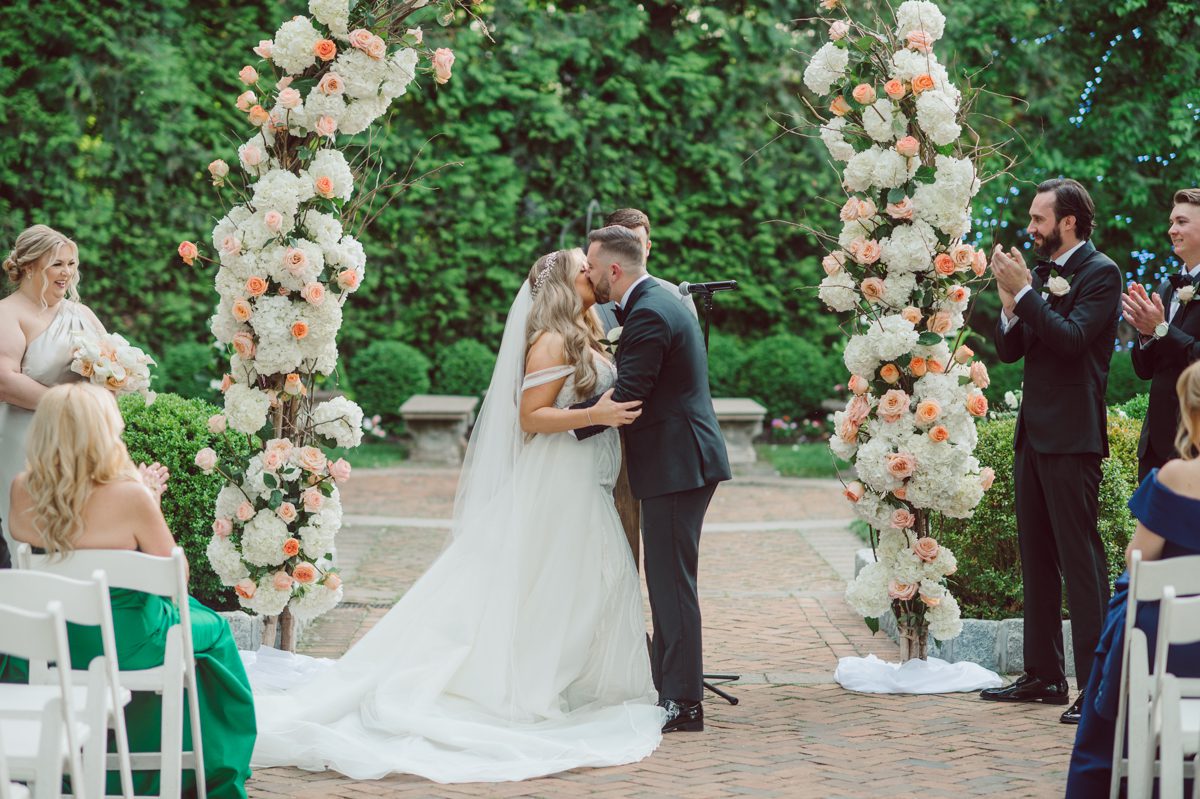 At Florentine Gardens in River Vale NJ celebrating Sam and Mike's wedding. Here at Florentine Gardens you'll get your amazing ballroom, gorgeous landscaped garden and during Sam and Mike's wedding day the roses were in full bloom it was truly beautiful. With roses in full bloom at the rose garden in Florentine Gardens, Sam and Mike's outdoor wedding ceremony was gorgeous bit hot but so gorgeous. And we were fully able to enjoy the roses during Sam and Mike's wedding portrait session. Sam and Mike's Florentine Gardens, NJ wedding captured by Karis from Hey Karis NY, NJ, Brooklyn, Hudson Valley and Catskills Wedding and Elopement Photographer.