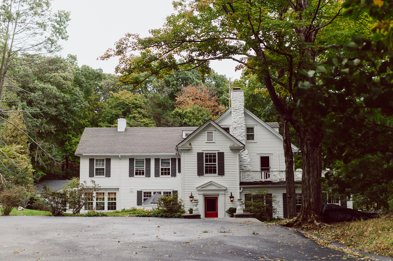 It got chilly over night but at least it wasn't raining. Just overcast which I can deal with and gladly take over rainy wedding day. My drive to Croton on Hudson NY was very smooth and scenic. The neighborhood near the Greta's Lakewood House on Croton on Hudson NY was very picturesque. I love driving through a small winding roads with unique farm houses along the way. Just as Elayne and Alexei explained I saw a white gate house on the Quaker Ridge Road, that I my entrance to Greta's Lakewood House on Croton on Hudson, NY. Drove in to the estate following the long driveway and found the Lakewood House with red door. As I was pulling in to a parking spot I saw Elayne and Alexei come out of the back door together holding a tray of French Fries. Why was I not surprised that they were together on the morning of their wedding day sharing a tray of French Fries together. They looked themselves, calm, happy and in love. I was early, so I walked around the property getting some landscape and exterior photo of this beautiful place. Elayne and Alexei of course got ready separately in their own little house on the property on their own. Elayne quietly did her own makeup and hair and got into her wedding dress all on her own! Even put together her own bouquet! I as Alexei getting bit nervous as he was getting ready, reading Elayne's card, wiring his vow. Around only 20 people were invited to this very private, intimate wedding celebration. Elayne and Alexei looking at each other read their wedding vows, ring on each hand, broke the glass and kissed. The rest of the day fell in to it's place naturally and organically without any coordinator or wedding planner following around every step of the way. They chatted with friends and family, drank champagne, and sat down for family style dinner. It was such a lovely moment watching everyone sharing meal, laughing and loving. Elayne and Alexei ended their wedding day with a bonfire by the Lakewood House. Elayne and Alexei's intimate Lakewood House Croton on Hudson NY wedding captured by Karis from Hey Karis New York, Brooklyn, Hudson Valley and Catskills Wedding Photographer and NYC Elopement Photographer.