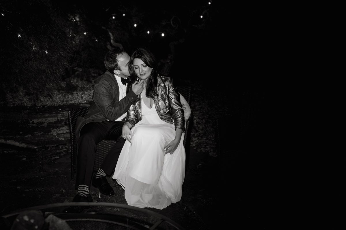 It got chilly over night but at least it wasn't raining. Just overcast which I can deal with and gladly take over rainy wedding day. My drive to Croton on Hudson NY was very smooth and scenic. The neighborhood near the Greta's Lakewood House on Croton on Hudson NY was very picturesque. I love driving through a small winding roads with unique farm houses along the way. Just as Elayne and Alexei explained I saw a white gate house on the Quaker Ridge Road, that I my entrance to Greta's Lakewood House on Croton on Hudson, NY. Drove in to the estate following the long driveway and found the Lakewood House with red door. As I was pulling in to a parking spot I saw Elayne and Alexei come out of the back door together holding a tray of French Fries. Why was I not surprised that they were together on the morning of their wedding day sharing a tray of French Fries together. They looked themselves, calm, happy and in love. I was early, so I walked around the property getting some landscape and exterior photo of this beautiful place. Elayne and Alexei of course got ready separately in their own little house on the property on their own. Elayne quietly did her own makeup and hair and got into her wedding dress all on her own! Even put together her own bouquet! I as Alexei getting bit nervous as he was getting ready, reading Elayne's card, wiring his vow. Around only 20 people were invited to this very private, intimate wedding celebration. Elayne and Alexei looking at each other read their wedding vows, ring on each hand, broke the glass and kissed. The rest of the day fell in to it's place naturally and organically without any coordinator or wedding planner following around every step of the way. They chatted with friends and family, drank champagne, and sat down for family style dinner. It was such a lovely moment watching everyone sharing meal, laughing and loving. Elayne and Alexei ended their wedding day with a bonfire by the Lakewood House. Elayne and Alexei's intimate Lakewood House Croton on Hudson NY wedding captured by Karis from Hey Karis New York, Brooklyn, Hudson Valley and Catskills Wedding Photographer and NYC Elopement Photographer.