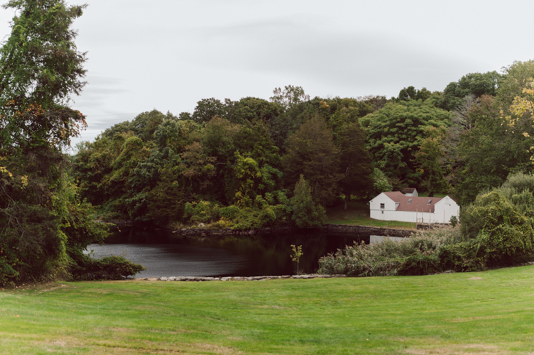 It got chilly over night but at least it wasn't raining. Just overcast which I can deal with and gladly take over rainy wedding day. My drive to Croton on Hudson NY was very smooth and scenic. The neighborhood near the Greta's Lakewood House on Croton on Hudson NY was very picturesque. I love driving through a small winding roads with unique farm houses along the way. Just as Elayne and Alexei explained I saw a white gate house on the Quaker Ridge Road, that I my entrance to Greta's Lakewood House on Croton on Hudson, NY. Drove in to the estate following the long driveway and found the Lakewood House with red door. As I was pulling in to a parking spot I saw Elayne and Alexei come out of the back door together holding a tray of French Fries. Why was I not surprised that they were together on the morning of their wedding day sharing a tray of French Fries together. They looked themselves, calm, happy and in love. I was early, so I walked around the property getting some landscape and exterior photo of this beautiful place. Elayne and Alexei of course got ready separately in their own little house on the property on their own. Elayne quietly did her own makeup and hair and got into her wedding dress all on her own! Even put together her own bouquet! I as Alexei getting bit nervous as he was getting ready, reading Elayne's card, wiring his vow. Around only 20 people were invited to this very private, intimate wedding celebration. Elayne and Alexei looking at each other read their wedding vows, ring on each hand, broke the glass and kissed. The rest of the day fell in to it's place naturally and organically without any coordinator or wedding planner following around every step of the way. They chatted with friends and family, drank champagne, and sat down for family style dinner. It was such a lovely moment watching everyone sharing meal, laughing and loving. Elayne and Alexei ended their wedding day with a bonfire by the Lakewood House. Elayne and Alexei's intimate Lakewood House Croton on Hudson NY wedding captured by Karis from Hey Karis New York, Brooklyn, Hudson Valley and Catskills Wedding Photographer and NYC Elopement Photographer.