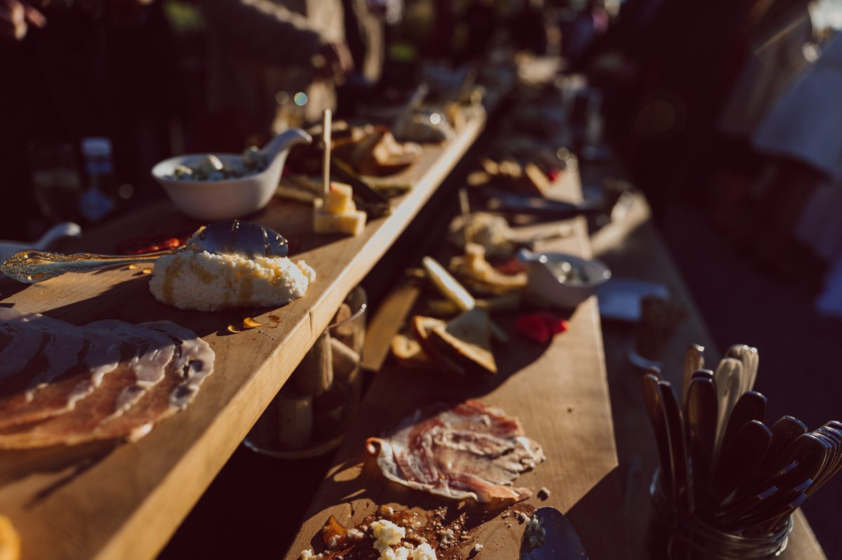 Talking about climate change (global warming) we've been having weirdly warm almost hot Fall. So we were hoping so another warm day for Becca and Dan's wedding on October 8, 2022 but unfortunately non of us were that lucky and it was pretty chilly. Especially at The Farm at Glenwood Mountain NJ which is pretty Northern NJ it felt or was colder, windier and just chillier. Thankfully I brought the right jacket for the chilly wind on the top of Glenwood Mountain but OMG I felt so bad for my bride Becca only wearing her lace wedding dress standing outside on top of Glenwood Mountain during the wedding ceremony. But before I talk about the wedding ceremony let's start from Becca and Dan's wedding prep which took place onsite at The Farm at Glenwood Mountain in Sussex NJ. Becca got ready cozy in the bridal suit when Dan just got ready by the Barn at The Farm at Glenwood Mountain and we went straight into Becca and Dan's first look next to the Highland Cows! Cutest fluffy Highland Cows were all out by the field and chilled while we took some wedding portraits of Becca and Dan. One of the many reasons "I LOVE" this wedding venue "The Farm at Glenwood Mountain" is because of these adorable Fluffy Cows called Highland Cows! I can stare at the all day long and take photo of them all day long. After Becca and Dan's first look, wedding portraits and family photos were done I walked up to the hill to Becca and Dan's outdoor ceremony area on top of the hill at The Farm at Glenwood Mountain and along the way I saw more cute baby Highland Cows to photograph and stare and wave hello. Watched guests arrive in a Yellow School bus in any rustic Farm wedding style and was them walk up the hill. Following the path, the fence with The Barn at their backdrop. Sun was out, it was clear gorgeous day but bit chilly and definitely way windy on top of the hill. My groom Dan came up along with their dog Dash (Dasher), then finally Becca arrived with her parents along side her. Ceremony started quickly knowing that guests and bride probably are freezing, Wind kept moving the cloud in and out making me change my exposure non stop. Wind blew hard, moving Becca's hair all over the place. But non the less it was sincere and beautiful wedding ceremony surrounded by nature, trees and Highland Cows Becca and Dan said their wedding vows followed by I do's. Sealing the wedding ceremony with a kiss Becca and Dan walked down the aisle quickly as possible to bundle Becca in to something warm. Amazing food, spread and hors d'oeuvres were passed out and when the sun was setting everyone made their way in to the barn for warmth and to seated for Becca and Dan's wedding reception. Gorgeous structured barn at The Farm at Glenwood Mountain is definitely not your typical too rustic and broken down barn, the barn here is new, clean, architectural and gorgeous! The owner Chef Steve even makes everyone take off their shoes if we need to enter the barn before the reception. Just like that Becca and Dan danced and partied their way into the night and it was already time for their barn fire and s'mores time outside. Becca and Dan's The Farm at Glenwood Mountain Sussex NJ wedding captured by Karis from Hey Karis New York, Brooklyn, Hudson Valley and Catskills Wedding Photographer and NYC Elopement Photographer.
