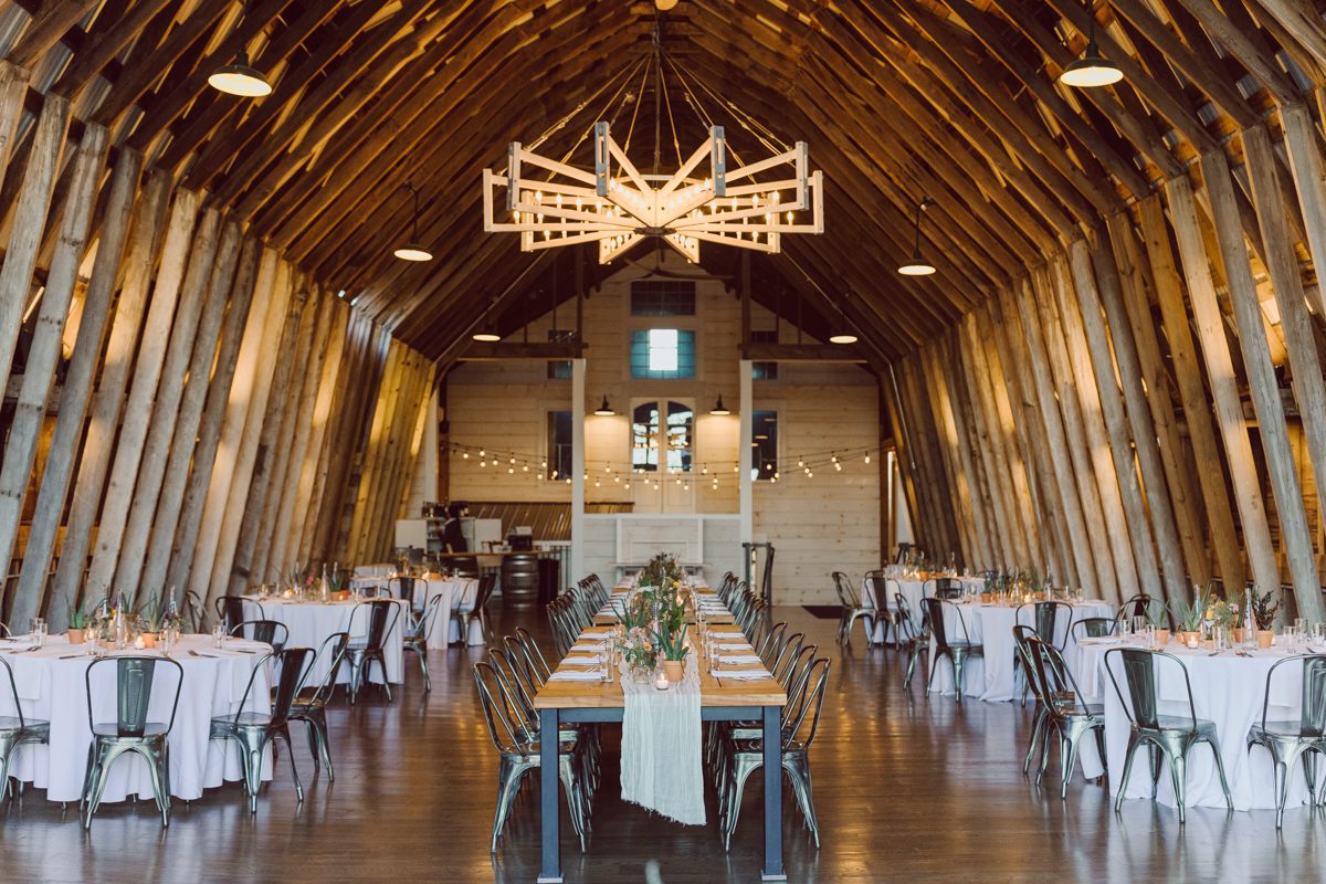 Talking about climate change (global warming) we've been having weirdly warm almost hot Fall. So we were hoping so another warm day for Becca and Dan's wedding on October 8, 2022 but unfortunately non of us were that lucky and it was pretty chilly. Especially at The Farm at Glenwood Mountain NJ which is pretty Northern NJ it felt or was colder, windier and just chillier. Thankfully I brought the right jacket for the chilly wind on the top of Glenwood Mountain but OMG I felt so bad for my bride Becca only wearing her lace wedding dress standing outside on top of Glenwood Mountain during the wedding ceremony. But before I talk about the wedding ceremony let's start from Becca and Dan's wedding prep which took place onsite at The Farm at Glenwood Mountain in Sussex NJ. Becca got ready cozy in the bridal suit when Dan just got ready by the Barn at The Farm at Glenwood Mountain and we went straight into Becca and Dan's first look next to the Highland Cows! Cutest fluffy Highland Cows were all out by the field and chilled while we took some wedding portraits of Becca and Dan. One of the many reasons "I LOVE" this wedding venue "The Farm at Glenwood Mountain" is because of these adorable Fluffy Cows called Highland Cows! I can stare at the all day long and take photo of them all day long. After Becca and Dan's first look, wedding portraits and family photos were done I walked up to the hill to Becca and Dan's outdoor ceremony area on top of the hill at The Farm at Glenwood Mountain and along the way I saw more cute baby Highland Cows to photograph and stare and wave hello. Watched guests arrive in a Yellow School bus in any rustic Farm wedding style and was them walk up the hill. Following the path, the fence with The Barn at their backdrop. Sun was out, it was clear gorgeous day but bit chilly and definitely way windy on top of the hill. My groom Dan came up along with their dog Dash (Dasher), then finally Becca arrived with her parents along side her. Ceremony started quickly knowing that guests and bride probably are freezing, Wind kept moving the cloud in and out making me change my exposure non stop. Wind blew hard, moving Becca's hair all over the place. But non the less it was sincere and beautiful wedding ceremony surrounded by nature, trees and Highland Cows Becca and Dan said their wedding vows followed by I do's. Sealing the wedding ceremony with a kiss Becca and Dan walked down the aisle quickly as possible to bundle Becca in to something warm. Amazing food, spread and hors d'oeuvres were passed out and when the sun was setting everyone made their way in to the barn for warmth and to seated for Becca and Dan's wedding reception. Gorgeous structured barn at The Farm at Glenwood Mountain is definitely not your typical too rustic and broken down barn, the barn here is new, clean, architectural and gorgeous! The owner Chef Steve even makes everyone take off their shoes if we need to enter the barn before the reception. Just like that Becca and Dan danced and partied their way into the night and it was already time for their barn fire and s'mores time outside. Becca and Dan's The Farm at Glenwood Mountain Sussex NJ wedding captured by Karis from Hey Karis New York, Brooklyn, Hudson Valley and Catskills Wedding Photographer and NYC Elopement Photographer.
