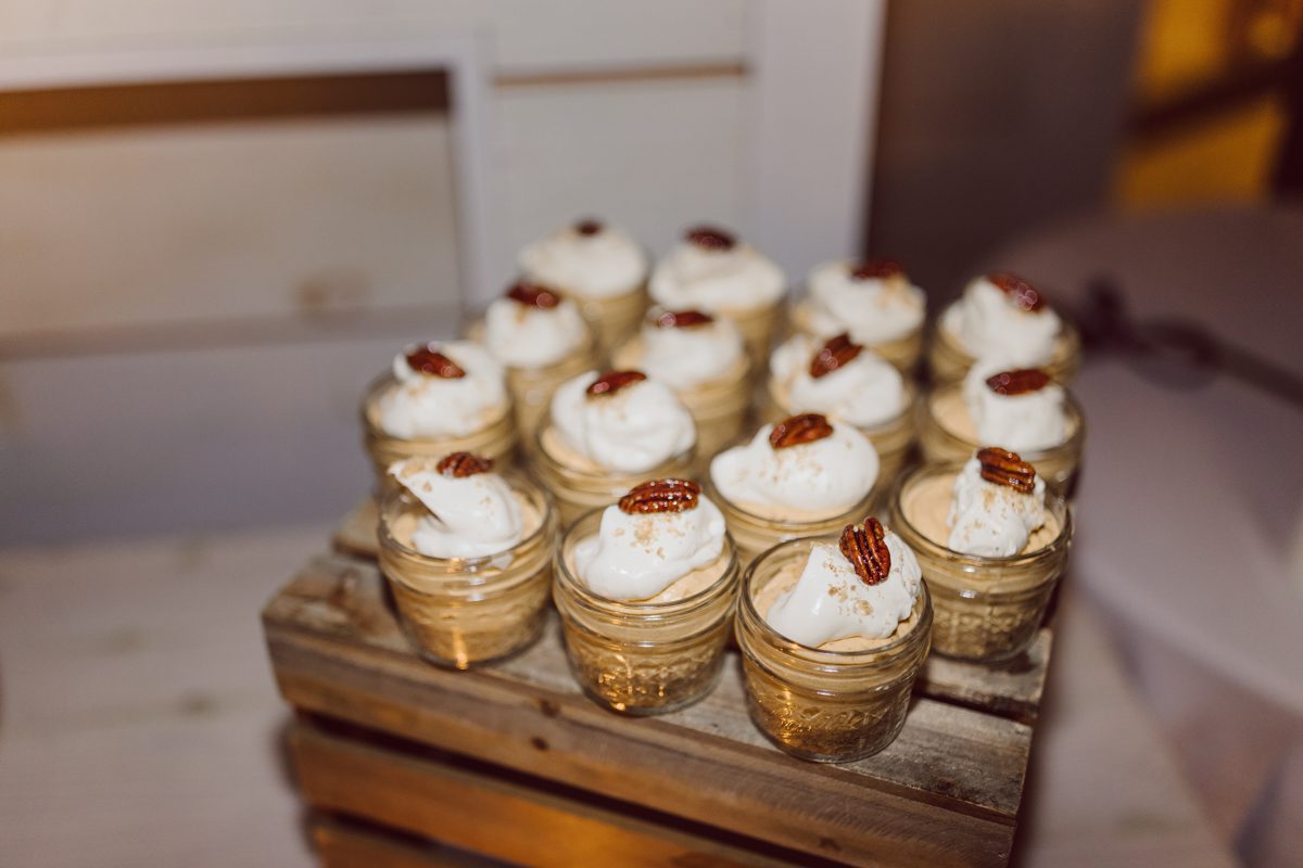 Talking about climate change (global warming) we've been having weirdly warm almost hot Fall. So we were hoping so another warm day for Becca and Dan's wedding on October 8, 2022 but unfortunately non of us were that lucky and it was pretty chilly. Especially at The Farm at Glenwood Mountain NJ which is pretty Northern NJ it felt or was colder, windier and just chillier. Thankfully I brought the right jacket for the chilly wind on the top of Glenwood Mountain but OMG I felt so bad for my bride Becca only wearing her lace wedding dress standing outside on top of Glenwood Mountain during the wedding ceremony. But before I talk about the wedding ceremony let's start from Becca and Dan's wedding prep which took place onsite at The Farm at Glenwood Mountain in Sussex NJ. Becca got ready cozy in the bridal suit when Dan just got ready by the Barn at The Farm at Glenwood Mountain and we went straight into Becca and Dan's first look next to the Highland Cows! Cutest fluffy Highland Cows were all out by the field and chilled while we took some wedding portraits of Becca and Dan. One of the many reasons "I LOVE" this wedding venue "The Farm at Glenwood Mountain" is because of these adorable Fluffy Cows called Highland Cows! I can stare at the all day long and take photo of them all day long. After Becca and Dan's first look, wedding portraits and family photos were done I walked up to the hill to Becca and Dan's outdoor ceremony area on top of the hill at The Farm at Glenwood Mountain and along the way I saw more cute baby Highland Cows to photograph and stare and wave hello. Watched guests arrive in a Yellow School bus in any rustic Farm wedding style and was them walk up the hill. Following the path, the fence with The Barn at their backdrop. Sun was out, it was clear gorgeous day but bit chilly and definitely way windy on top of the hill. My groom Dan came up along with their dog Dash (Dasher), then finally Becca arrived with her parents along side her. Ceremony started quickly knowing that guests and bride probably are freezing, Wind kept moving the cloud in and out making me change my exposure non stop. Wind blew hard, moving Becca's hair all over the place. But non the less it was sincere and beautiful wedding ceremony surrounded by nature, trees and Highland Cows Becca and Dan said their wedding vows followed by I do's. Sealing the wedding ceremony with a kiss Becca and Dan walked down the aisle quickly as possible to bundle Becca in to something warm. Amazing food, spread and hors d'oeuvres were passed out and when the sun was setting everyone made their way in to the barn for warmth and to seated for Becca and Dan's wedding reception. Gorgeous structured barn at The Farm at Glenwood Mountain is definitely not your typical too rustic and broken down barn, the barn here is new, clean, architectural and gorgeous! The owner Chef Steve even makes everyone take off their shoes if we need to enter the barn before the reception. Just like that Becca and Dan danced and partied their way into the night and it was already time for their barn fire and s'mores time outside. Becca and Dan's The Farm at Glenwood Mountain Sussex NJ wedding captured by Karis from Hey Karis New York, Brooklyn, Hudson Valley and Catskills Wedding Photographer and NYC Elopement Photographer.
