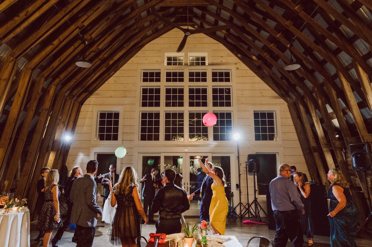 Talking about climate change (global warming) we've been having weirdly warm almost hot Fall. So we were hoping so another warm day for Becca and Dan's wedding on October 8, 2022 but unfortunately non of us were that lucky and it was pretty chilly. Especially at The Farm at Glenwood Mountain NJ which is pretty Northern NJ it felt or was colder, windier and just chillier. Thankfully I brought the right jacket for the chilly wind on the top of Glenwood Mountain but OMG I felt so bad for my bride Becca only wearing her lace wedding dress standing outside on top of Glenwood Mountain during the wedding ceremony. But before I talk about the wedding ceremony let's start from Becca and Dan's wedding prep which took place onsite at The Farm at Glenwood Mountain in Sussex NJ. Becca got ready cozy in the bridal suit when Dan just got ready by the Barn at The Farm at Glenwood Mountain and we went straight into Becca and Dan's first look next to the Highland Cows! Cutest fluffy Highland Cows were all out by the field and chilled while we took some wedding portraits of Becca and Dan. One of the many reasons "I LOVE" this wedding venue "The Farm at Glenwood Mountain" is because of these adorable Fluffy Cows called Highland Cows! I can stare at the all day long and take photo of them all day long. After Becca and Dan's first look, wedding portraits and family photos were done I walked up to the hill to Becca and Dan's outdoor ceremony area on top of the hill at The Farm at Glenwood Mountain and along the way I saw more cute baby Highland Cows to photograph and stare and wave hello. Watched guests arrive in a Yellow School bus in any rustic Farm wedding style and was them walk up the hill. Following the path, the fence with The Barn at their backdrop. Sun was out, it was clear gorgeous day but bit chilly and definitely way windy on top of the hill. My groom Dan came up along with their dog Dash (Dasher), then finally Becca arrived with her parents along side her. Ceremony started quickly knowing that guests and bride probably are freezing, Wind kept moving the cloud in and out making me change my exposure non stop. Wind blew hard, moving Becca's hair all over the place. But non the less it was sincere and beautiful wedding ceremony surrounded by nature, trees and Highland Cows Becca and Dan said their wedding vows followed by I do's. Sealing the wedding ceremony with a kiss Becca and Dan walked down the aisle quickly as possible to bundle Becca in to something warm. Amazing food, spread and hors d'oeuvres were passed out and when the sun was setting everyone made their way in to the barn for warmth and to seated for Becca and Dan's wedding reception. Gorgeous structured barn at The Farm at Glenwood Mountain is definitely not your typical too rustic and broken down barn, the barn here is new, clean, architectural and gorgeous! The owner Chef Steve even makes everyone take off their shoes if we need to enter the barn before the reception. Just like that Becca and Dan danced and partied their way into the night and it was already time for their barn fire and s'mores time outside. Becca and Dan's The Farm at Glenwood Mountain Sussex NJ wedding captured by Karis from Hey Karis New York, Brooklyn, Hudson Valley and Catskills Wedding Photographer and NYC Elopement Photographer.