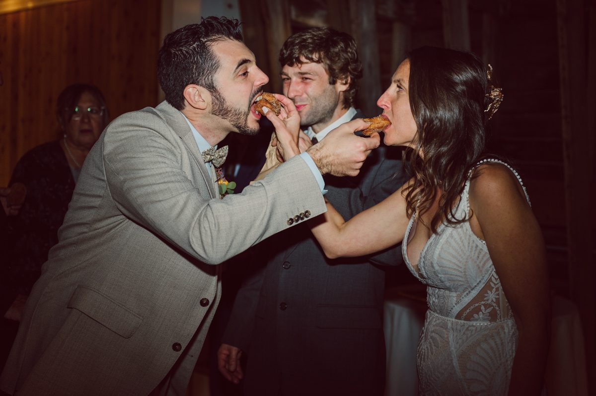 Talking about climate change (global warming) we've been having weirdly warm almost hot Fall. So we were hoping so another warm day for Becca and Dan's wedding on October 8, 2022 but unfortunately non of us were that lucky and it was pretty chilly. Especially at The Farm at Glenwood Mountain NJ which is pretty Northern NJ it felt or was colder, windier and just chillier. Thankfully I brought the right jacket for the chilly wind on the top of Glenwood Mountain but OMG I felt so bad for my bride Becca only wearing her lace wedding dress standing outside on top of Glenwood Mountain during the wedding ceremony. But before I talk about the wedding ceremony let's start from Becca and Dan's wedding prep which took place onsite at The Farm at Glenwood Mountain in Sussex NJ. Becca got ready cozy in the bridal suit when Dan just got ready by the Barn at The Farm at Glenwood Mountain and we went straight into Becca and Dan's first look next to the Highland Cows! Cutest fluffy Highland Cows were all out by the field and chilled while we took some wedding portraits of Becca and Dan. One of the many reasons "I LOVE" this wedding venue "The Farm at Glenwood Mountain" is because of these adorable Fluffy Cows called Highland Cows! I can stare at the all day long and take photo of them all day long. After Becca and Dan's first look, wedding portraits and family photos were done I walked up to the hill to Becca and Dan's outdoor ceremony area on top of the hill at The Farm at Glenwood Mountain and along the way I saw more cute baby Highland Cows to photograph and stare and wave hello. Watched guests arrive in a Yellow School bus in any rustic Farm wedding style and was them walk up the hill. Following the path, the fence with The Barn at their backdrop. Sun was out, it was clear gorgeous day but bit chilly and definitely way windy on top of the hill. My groom Dan came up along with their dog Dash (Dasher), then finally Becca arrived with her parents along side her. Ceremony started quickly knowing that guests and bride probably are freezing, Wind kept moving the cloud in and out making me change my exposure non stop. Wind blew hard, moving Becca's hair all over the place. But non the less it was sincere and beautiful wedding ceremony surrounded by nature, trees and Highland Cows Becca and Dan said their wedding vows followed by I do's. Sealing the wedding ceremony with a kiss Becca and Dan walked down the aisle quickly as possible to bundle Becca in to something warm. Amazing food, spread and hors d'oeuvres were passed out and when the sun was setting everyone made their way in to the barn for warmth and to seated for Becca and Dan's wedding reception. Gorgeous structured barn at The Farm at Glenwood Mountain is definitely not your typical too rustic and broken down barn, the barn here is new, clean, architectural and gorgeous! The owner Chef Steve even makes everyone take off their shoes if we need to enter the barn before the reception. Just like that Becca and Dan danced and partied their way into the night and it was already time for their barn fire and s'mores time outside. Becca and Dan's The Farm at Glenwood Mountain Sussex NJ wedding captured by Karis from Hey Karis New York, Brooklyn, Hudson Valley and Catskills Wedding Photographer and NYC Elopement Photographer.
