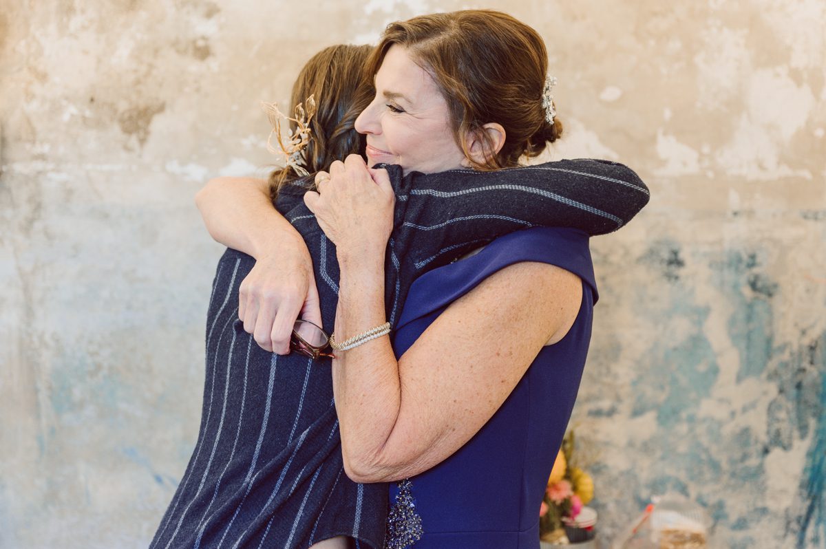 Talking about climate change (global warming) we've been having weirdly warm almost hot Fall. So we were hoping so another warm day for Becca and Dan's wedding on October 8, 2022 but unfortunately non of us were that lucky and it was pretty chilly. Especially at The Farm at Glenwood Mountain NJ which is pretty Northern NJ it felt or was colder, windier and just chillier. Thankfully I brought the right jacket for the chilly wind on the top of Glenwood Mountain but OMG I felt so bad for my bride Becca only wearing her lace wedding dress standing outside on top of Glenwood Mountain during the wedding ceremony. But before I talk about the wedding ceremony let's start from Becca and Dan's wedding prep which took place onsite at The Farm at Glenwood Mountain in Sussex NJ. Becca got ready cozy in the bridal suit when Dan just got ready by the Barn at The Farm at Glenwood Mountain and we went straight into Becca and Dan's first look next to the Highland Cows! Cutest fluffy Highland Cows were all out by the field and chilled while we took some wedding portraits of Becca and Dan. One of the many reasons "I LOVE" this wedding venue "The Farm at Glenwood Mountain" is because of these adorable Fluffy Cows called Highland Cows! I can stare at the all day long and take photo of them all day long. After Becca and Dan's first look, wedding portraits and family photos were done I walked up to the hill to Becca and Dan's outdoor ceremony area on top of the hill at The Farm at Glenwood Mountain and along the way I saw more cute baby Highland Cows to photograph and stare and wave hello. Watched guests arrive in a Yellow School bus in any rustic Farm wedding style and was them walk up the hill. Following the path, the fence with The Barn at their backdrop. Sun was out, it was clear gorgeous day but bit chilly and definitely way windy on top of the hill. My groom Dan came up along with their dog Dash (Dasher), then finally Becca arrived with her parents along side her. Ceremony started quickly knowing that guests and bride probably are freezing, Wind kept moving the cloud in and out making me change my exposure non stop. Wind blew hard, moving Becca's hair all over the place. But non the less it was sincere and beautiful wedding ceremony surrounded by nature, trees and Highland Cows Becca and Dan said their wedding vows followed by I do's. Sealing the wedding ceremony with a kiss Becca and Dan walked down the aisle quickly as possible to bundle Becca in to something warm. Amazing food, spread and hors d'oeuvres were passed out and when the sun was setting everyone made their way in to the barn for warmth and to seated for Becca and Dan's wedding reception. Gorgeous structured barn at The Farm at Glenwood Mountain is definitely not your typical too rustic and broken down barn, the barn here is new, clean, architectural and gorgeous! The owner Chef Steve even makes everyone take off their shoes if we need to enter the barn before the reception. Just like that Becca and Dan danced and partied their way into the night and it was already time for their barn fire and s'mores time outside. Becca and Dan's The Farm at Glenwood Mountain Sussex NJ wedding captured by Karis from Hey Karis New York, Brooklyn, Hudson Valley and Catskills Wedding Photographer and NYC Elopement Photographer.
