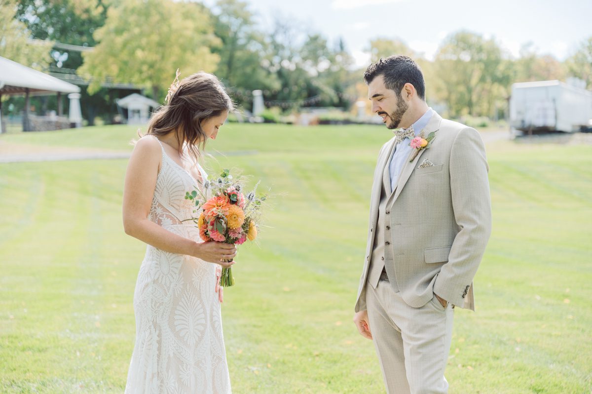 Talking about climate change (global warming) we've been having weirdly warm almost hot Fall. So we were hoping so another warm day for Becca and Dan's wedding on October 8, 2022 but unfortunately non of us were that lucky and it was pretty chilly. Especially at The Farm at Glenwood Mountain NJ which is pretty Northern NJ it felt or was colder, windier and just chillier. Thankfully I brought the right jacket for the chilly wind on the top of Glenwood Mountain but OMG I felt so bad for my bride Becca only wearing her lace wedding dress standing outside on top of Glenwood Mountain during the wedding ceremony. But before I talk about the wedding ceremony let's start from Becca and Dan's wedding prep which took place onsite at The Farm at Glenwood Mountain in Sussex NJ. Becca got ready cozy in the bridal suit when Dan just got ready by the Barn at The Farm at Glenwood Mountain and we went straight into Becca and Dan's first look next to the Highland Cows! Cutest fluffy Highland Cows were all out by the field and chilled while we took some wedding portraits of Becca and Dan. One of the many reasons "I LOVE" this wedding venue "The Farm at Glenwood Mountain" is because of these adorable Fluffy Cows called Highland Cows! I can stare at the all day long and take photo of them all day long. After Becca and Dan's first look, wedding portraits and family photos were done I walked up to the hill to Becca and Dan's outdoor ceremony area on top of the hill at The Farm at Glenwood Mountain and along the way I saw more cute baby Highland Cows to photograph and stare and wave hello. Watched guests arrive in a Yellow School bus in any rustic Farm wedding style and was them walk up the hill. Following the path, the fence with The Barn at their backdrop. Sun was out, it was clear gorgeous day but bit chilly and definitely way windy on top of the hill. My groom Dan came up along with their dog Dash (Dasher), then finally Becca arrived with her parents along side her. Ceremony started quickly knowing that guests and bride probably are freezing, Wind kept moving the cloud in and out making me change my exposure non stop. Wind blew hard, moving Becca's hair all over the place. But non the less it was sincere and beautiful wedding ceremony surrounded by nature, trees and Highland Cows Becca and Dan said their wedding vows followed by I do's. Sealing the wedding ceremony with a kiss Becca and Dan walked down the aisle quickly as possible to bundle Becca in to something warm. Amazing food, spread and hors d'oeuvres were passed out and when the sun was setting everyone made their way in to the barn for warmth and to seated for Becca and Dan's wedding reception. Gorgeous structured barn at The Farm at Glenwood Mountain is definitely not your typical too rustic and broken down barn, the barn here is new, clean, architectural and gorgeous! The owner Chef Steve even makes everyone take off their shoes if we need to enter the barn before the reception. Just like that Becca and Dan danced and partied their way into the night and it was already time for their barn fire and s'mores time outside. Becca and Dan's The Farm at Glenwood Mountain Sussex NJ wedding captured by Karis from Hey Karis New York, Brooklyn, Hudson Valley and Catskills Wedding Photographer and NYC Elopement Photographer.

