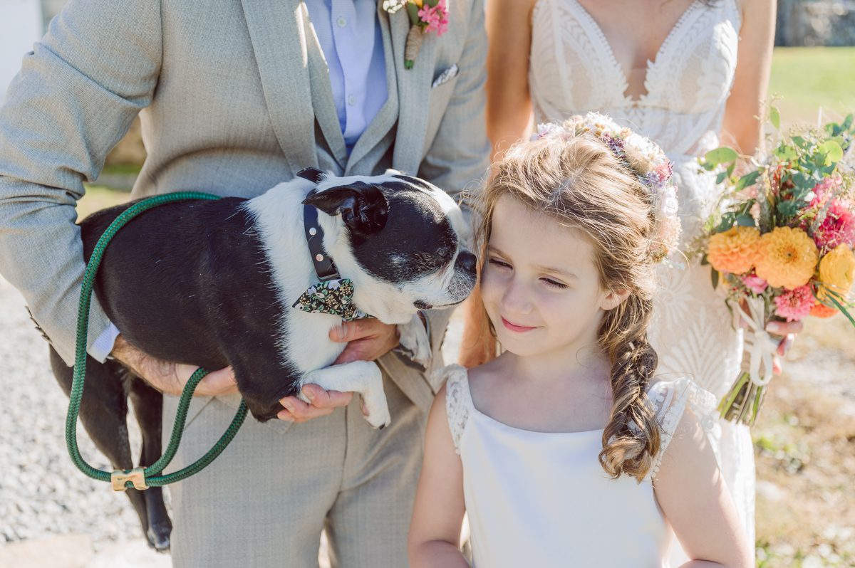 Talking about climate change (global warming) we've been having weirdly warm almost hot Fall. So we were hoping so another warm day for Becca and Dan's wedding on October 8, 2022 but unfortunately non of us were that lucky and it was pretty chilly. Especially at The Farm at Glenwood Mountain NJ which is pretty Northern NJ it felt or was colder, windier and just chillier. Thankfully I brought the right jacket for the chilly wind on the top of Glenwood Mountain but OMG I felt so bad for my bride Becca only wearing her lace wedding dress standing outside on top of Glenwood Mountain during the wedding ceremony. But before I talk about the wedding ceremony let's start from Becca and Dan's wedding prep which took place onsite at The Farm at Glenwood Mountain in Sussex NJ. Becca got ready cozy in the bridal suit when Dan just got ready by the Barn at The Farm at Glenwood Mountain and we went straight into Becca and Dan's first look next to the Highland Cows! Cutest fluffy Highland Cows were all out by the field and chilled while we took some wedding portraits of Becca and Dan. One of the many reasons "I LOVE" this wedding venue "The Farm at Glenwood Mountain" is because of these adorable Fluffy Cows called Highland Cows! I can stare at the all day long and take photo of them all day long. After Becca and Dan's first look, wedding portraits and family photos were done I walked up to the hill to Becca and Dan's outdoor ceremony area on top of the hill at The Farm at Glenwood Mountain and along the way I saw more cute baby Highland Cows to photograph and stare and wave hello. Watched guests arrive in a Yellow School bus in any rustic Farm wedding style and was them walk up the hill. Following the path, the fence with The Barn at their backdrop. Sun was out, it was clear gorgeous day but bit chilly and definitely way windy on top of the hill. My groom Dan came up along with their dog Dash (Dasher), then finally Becca arrived with her parents along side her. Ceremony started quickly knowing that guests and bride probably are freezing, Wind kept moving the cloud in and out making me change my exposure non stop. Wind blew hard, moving Becca's hair all over the place. But non the less it was sincere and beautiful wedding ceremony surrounded by nature, trees and Highland Cows Becca and Dan said their wedding vows followed by I do's. Sealing the wedding ceremony with a kiss Becca and Dan walked down the aisle quickly as possible to bundle Becca in to something warm. Amazing food, spread and hors d'oeuvres were passed out and when the sun was setting everyone made their way in to the barn for warmth and to seated for Becca and Dan's wedding reception. Gorgeous structured barn at The Farm at Glenwood Mountain is definitely not your typical too rustic and broken down barn, the barn here is new, clean, architectural and gorgeous! The owner Chef Steve even makes everyone take off their shoes if we need to enter the barn before the reception. Just like that Becca and Dan danced and partied their way into the night and it was already time for their barn fire and s'mores time outside. Becca and Dan's The Farm at Glenwood Mountain Sussex NJ wedding captured by Karis from Hey Karis New York, Brooklyn, Hudson Valley and Catskills Wedding Photographer and NYC Elopement Photographer.
