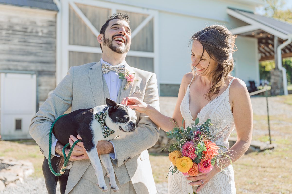 Talking about climate change (global warming) we've been having weirdly warm almost hot Fall. So we were hoping so another warm day for Becca and Dan's wedding on October 8, 2022 but unfortunately non of us were that lucky and it was pretty chilly. Especially at The Farm at Glenwood Mountain NJ which is pretty Northern NJ it felt or was colder, windier and just chillier. Thankfully I brought the right jacket for the chilly wind on the top of Glenwood Mountain but OMG I felt so bad for my bride Becca only wearing her lace wedding dress standing outside on top of Glenwood Mountain during the wedding ceremony. But before I talk about the wedding ceremony let's start from Becca and Dan's wedding prep which took place onsite at The Farm at Glenwood Mountain in Sussex NJ. Becca got ready cozy in the bridal suit when Dan just got ready by the Barn at The Farm at Glenwood Mountain and we went straight into Becca and Dan's first look next to the Highland Cows! Cutest fluffy Highland Cows were all out by the field and chilled while we took some wedding portraits of Becca and Dan. One of the many reasons "I LOVE" this wedding venue "The Farm at Glenwood Mountain" is because of these adorable Fluffy Cows called Highland Cows! I can stare at the all day long and take photo of them all day long. After Becca and Dan's first look, wedding portraits and family photos were done I walked up to the hill to Becca and Dan's outdoor ceremony area on top of the hill at The Farm at Glenwood Mountain and along the way I saw more cute baby Highland Cows to photograph and stare and wave hello. Watched guests arrive in a Yellow School bus in any rustic Farm wedding style and was them walk up the hill. Following the path, the fence with The Barn at their backdrop. Sun was out, it was clear gorgeous day but bit chilly and definitely way windy on top of the hill. My groom Dan came up along with their dog Dash (Dasher), then finally Becca arrived with her parents along side her. Ceremony started quickly knowing that guests and bride probably are freezing, Wind kept moving the cloud in and out making me change my exposure non stop. Wind blew hard, moving Becca's hair all over the place. But non the less it was sincere and beautiful wedding ceremony surrounded by nature, trees and Highland Cows Becca and Dan said their wedding vows followed by I do's. Sealing the wedding ceremony with a kiss Becca and Dan walked down the aisle quickly as possible to bundle Becca in to something warm. Amazing food, spread and hors d'oeuvres were passed out and when the sun was setting everyone made their way in to the barn for warmth and to seated for Becca and Dan's wedding reception. Gorgeous structured barn at The Farm at Glenwood Mountain is definitely not your typical too rustic and broken down barn, the barn here is new, clean, architectural and gorgeous! The owner Chef Steve even makes everyone take off their shoes if we need to enter the barn before the reception. Just like that Becca and Dan danced and partied their way into the night and it was already time for their barn fire and s'mores time outside. Becca and Dan's The Farm at Glenwood Mountain Sussex NJ wedding captured by Karis from Hey Karis New York, Brooklyn, Hudson Valley and Catskills Wedding Photographer and NYC Elopement Photographer.
