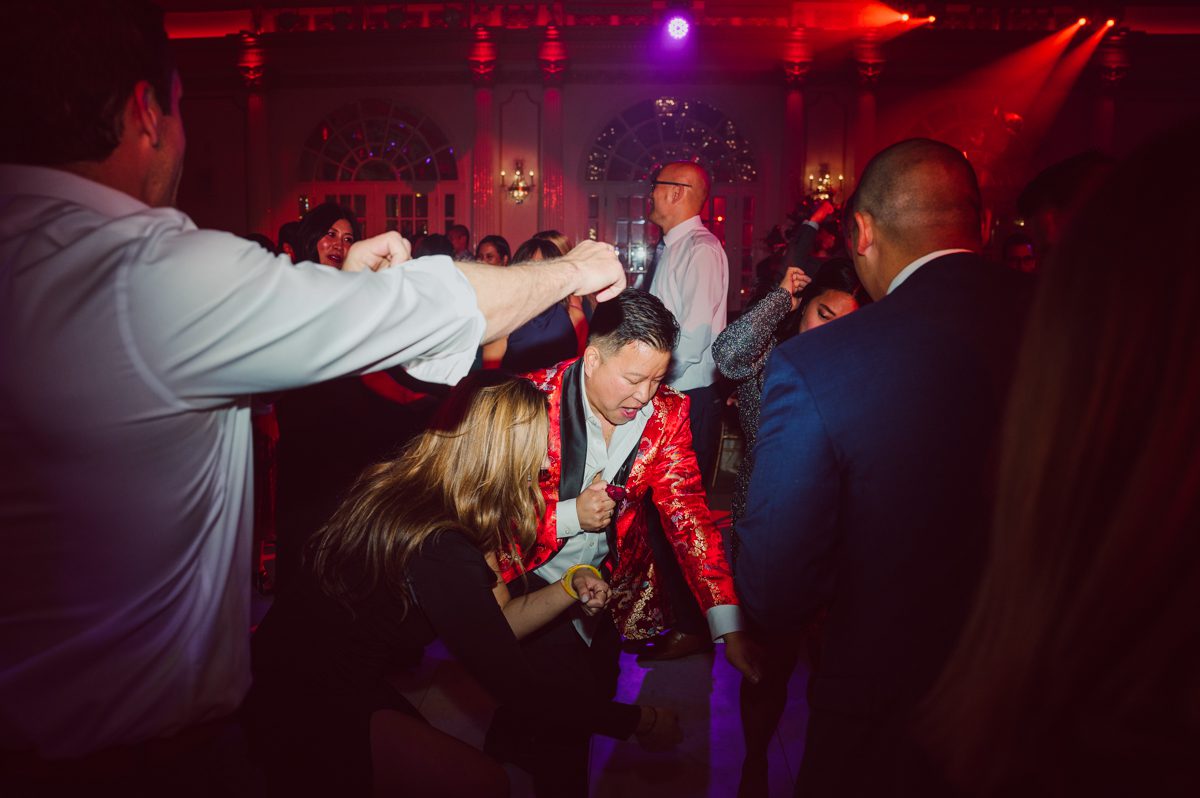 Connie and Richard who are Rick's parents inquired for their son's wedding since his son Rick and soon to be daughter in law currently lives in California and was planning their wedding in the West Coast. Connie and Richard are from here in NJ and was eager to help and plan their son's wedding here in the East Coast. Connie and Richard chose Crystal Plaza in Livingston NJ for their son's wedding venue here in NJ on October 29, 2022. Connie and Richard were delightful parents and young minded for first generation Chinese Americans, their english was fluent as well as their Chinese I was pleasantly surprised since I am second generation Korean-American and my immigrant Korean parents do not speak english that well. It was my first wedding where I did not get to meet the bride and groom till the wedding day. It made me bit nervous as I walked into the bridal suite at Crystal Plaza. But to my surprise Alison and Rick were super sweet and nice where we smoothly worked through the portrait session. Alison and Rick followed all my directions well, did everything I asked them to then it was time for PARTY! Cocktail hour at Crystal Plaza was impressive with spreads and tables of delicious food! I definitely enjoyed some of the delicious food during cocktail hour then walked into the reception room and i was WOWed. The house lights at Crystal Plaza was beautiful and it was actually amazing that I didn't even use my own lights. The mixture of house lights, fog and spotlights at Crystal Plaza was actually fabulous and I was very impressed. The house lights at Crystal Plaza made shutter drag dancing photos with double exposure so much fun and amazing! Alison and Rick, actually Connie and Richard even hired Chinese Lion Dancers for the reception and all the guests loved it. The energy during Alison and Rick's wedding reception was on FIRE! Everyone and anyone was on the dance floor dancing like it was their last one. I truly had a blast during Alison and Rick's wedding at Crystal Plaza in Livingston NJ and looking forward to going back to Crystal Plaza soon. Alison and Rick's Crystal Plaza in Livingston NJ wedding captured by Karis from Hey Karis New York, Brooklyn, Hudson Valley and Catskills Wedding Photographer and NYC Elopement Photographer.