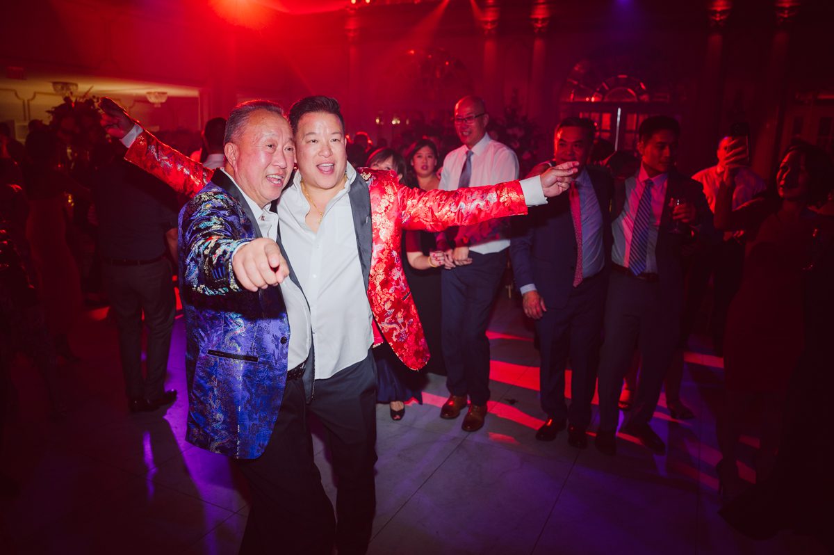 Connie and Richard who are Rick's parents inquired for their son's wedding since his son Rick and soon to be daughter in law currently lives in California and was planning their wedding in the West Coast. Connie and Richard are from here in NJ and was eager to help and plan their son's wedding here in the East Coast. Connie and Richard chose Crystal Plaza in Livingston NJ for their son's wedding venue here in NJ on October 29, 2022. Connie and Richard were delightful parents and young minded for first generation Chinese Americans, their english was fluent as well as their Chinese I was pleasantly surprised since I am second generation Korean-American and my immigrant Korean parents do not speak english that well. It was my first wedding where I did not get to meet the bride and groom till the wedding day. It made me bit nervous as I walked into the bridal suite at Crystal Plaza. But to my surprise Alison and Rick were super sweet and nice where we smoothly worked through the portrait session. Alison and Rick followed all my directions well, did everything I asked them to then it was time for PARTY! Cocktail hour at Crystal Plaza was impressive with spreads and tables of delicious food! I definitely enjoyed some of the delicious food during cocktail hour then walked into the reception room and i was WOWed. The house lights at Crystal Plaza was beautiful and it was actually amazing that I didn't even use my own lights. The mixture of house lights, fog and spotlights at Crystal Plaza was actually fabulous and I was very impressed. The house lights at Crystal Plaza made shutter drag dancing photos with double exposure so much fun and amazing! Alison and Rick, actually Connie and Richard even hired Chinese Lion Dancers for the reception and all the guests loved it. The energy during Alison and Rick's wedding reception was on FIRE! Everyone and anyone was on the dance floor dancing like it was their last one. I truly had a blast during Alison and Rick's wedding at Crystal Plaza in Livingston NJ and looking forward to going back to Crystal Plaza soon. Alison and Rick's Crystal Plaza in Livingston NJ wedding captured by Karis from Hey Karis New York, Brooklyn, Hudson Valley and Catskills Wedding Photographer and NYC Elopement Photographer.