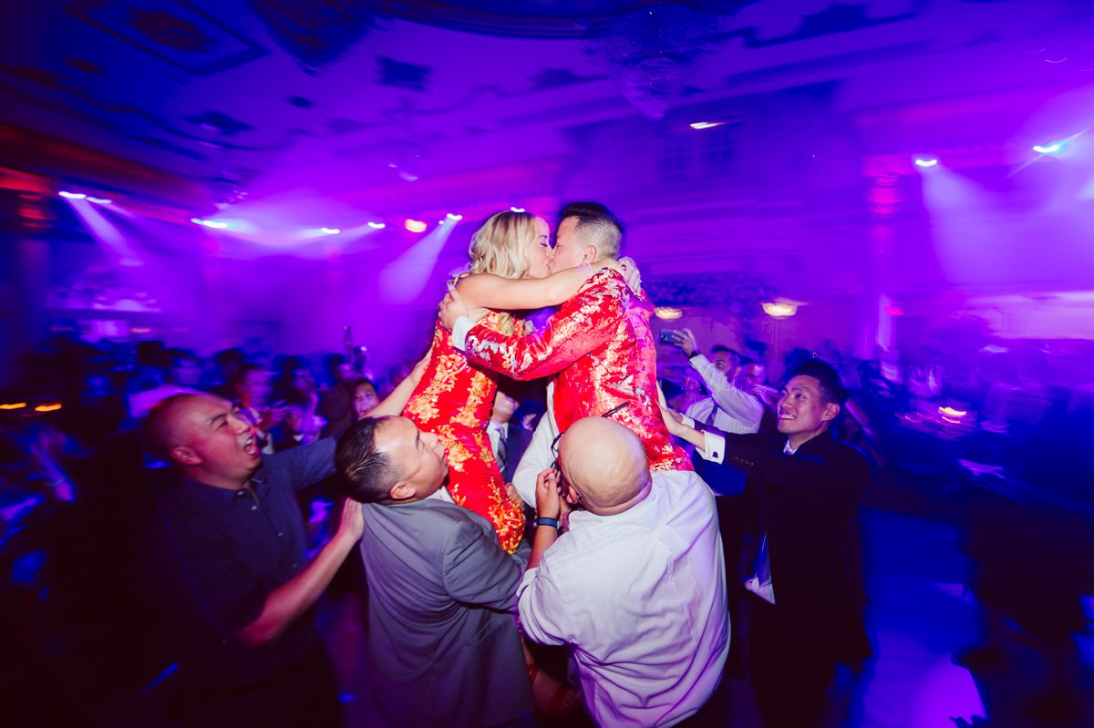 Connie and Richard who are Rick's parents inquired for their son's wedding since his son Rick and soon to be daughter in law currently lives in California and was planning their wedding in the West Coast. Connie and Richard are from here in NJ and was eager to help and plan their son's wedding here in the East Coast. Connie and Richard chose Crystal Plaza in Livingston NJ for their son's wedding venue here in NJ on October 29, 2022. Connie and Richard were delightful parents and young minded for first generation Chinese Americans, their english was fluent as well as their Chinese I was pleasantly surprised since I am second generation Korean-American and my immigrant Korean parents do not speak english that well. It was my first wedding where I did not get to meet the bride and groom till the wedding day. It made me bit nervous as I walked into the bridal suite at Crystal Plaza. But to my surprise Alison and Rick were super sweet and nice where we smoothly worked through the portrait session. Alison and Rick followed all my directions well, did everything I asked them to then it was time for PARTY! Cocktail hour at Crystal Plaza was impressive with spreads and tables of delicious food! I definitely enjoyed some of the delicious food during cocktail hour then walked into the reception room and i was WOWed. The house lights at Crystal Plaza was beautiful and it was actually amazing that I didn't even use my own lights. The mixture of house lights, fog and spotlights at Crystal Plaza was actually fabulous and I was very impressed. The house lights at Crystal Plaza made shutter drag dancing photos with double exposure so much fun and amazing! Alison and Rick, actually Connie and Richard even hired Chinese Lion Dancers for the reception and all the guests loved it. The energy during Alison and Rick's wedding reception was on FIRE! Everyone and anyone was on the dance floor dancing like it was their last one. I truly had a blast during Alison and Rick's wedding at Crystal Plaza in Livingston NJ and looking forward to going back to Crystal Plaza soon. Alison and Rick's Crystal Plaza in Livingston NJ wedding captured by Karis from Hey Karis New York, Brooklyn, Hudson Valley and Catskills Wedding Photographer and NYC Elopement Photographer.