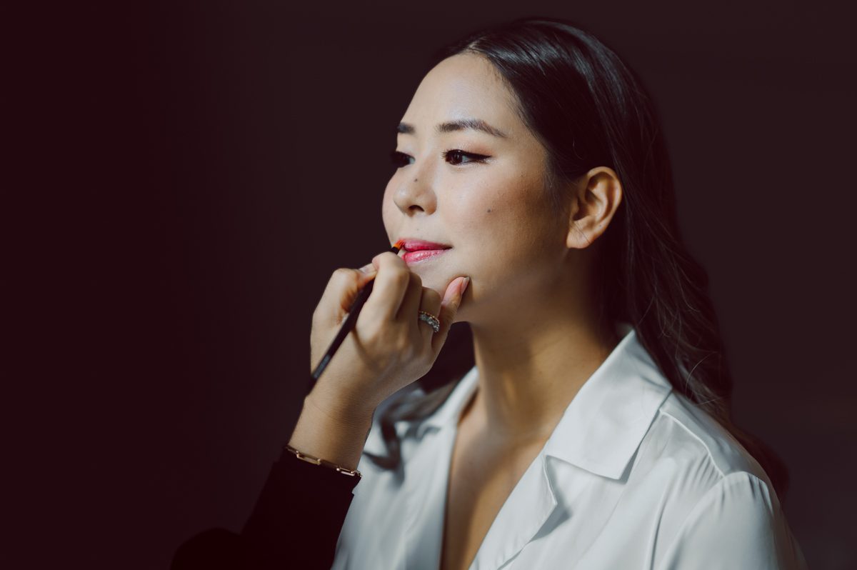 Duffield St, Brooklyn on November 19 even though it's Saturday morning it was still very busy. But luckily I found street parking right on Duffield St in front of Sheraton Downtown Brooklyn which was where I needed to be for Ariana and Jon's wedding prep. Vicky from VickyC5 hair/makeup team was there beautifying the ladies, I went straight to flat lays of Ariana's wedding details such as rings, jewelry and her wedding invitations. I use ribbons, extra loose flowers to make the flat lays more fine art looking. Once all the details are done, my full focus goes to the bride Ariana and her ladies. Ariana and Jon were planning to do a Chinese Door Game at the hotel room, so as soon as Ariana was ready in her Hanbok (Korean Traditional Wedding Outfit) Jon and his groomsmen arrived at the door. With Ariana's bridal suite crowded with too many people Ariana's bridesmaids started to give instructions to the games that Jon and his groomsmen need to play in order to get through the second door so that Jon can meet/see his bride Ariana. While the games are happening outside Ariana's door one of the bridesmaid has her phone on FaceTime so that Ariana can see how the men are doing during all the door games. I of course had my second shooter inside the room with Ariana to get her reactions which was hilarious. After the door games, we then moved to a conference room of at Sheraton Downtown Brooklyn for Ariana and Jon's Chinese Tea Pouring Ceremony (this is Jon's Chinese side's wedding tradition where you pour tea to all the elders in the family). Once all the Chines and Korean wedding traditions are over, we all rushed to Brooklyn Botanical Garden. Traffic from Sheraton Downtown Brooklyn to Brooklyn Botanical Garden was pretty bad, as usual. Once I arrived there of course was no street parking available near the entrance and parking lot for Brooklyn Botanical Garden was way too far for me to carry all the gears. After driving around I found one spot few blocks away from the Brooklyn Botanical Garden entrance. Brooklyn Botanical Garden was busy with Lightscape preparation and installation which we were not allowed to photograph so we were left with very little options for wedding portrait backdrop, plus it was COLD and we were looking light! These are important things to consider when you are planning for Winter wedding. I worked as quickly as possible with Ariana and Jon's first look and bridal party photos. Then we stayed inside for family photos since elders did not wanted to go outside which I totally don't blame. Then I quickly took Ariana and Jon outside for bit more couple's portraits then it was time for the wedding ceremony. Ariana and Jon's wedding ceremony held place at The Palm House at Brooklyn Botanical Garden, but because it was an winter wedding we've lost all the light and I had to use my video lights but over all the ceremony was beautiful and Oh Fleur NYC did absolutely an amazing job with ceremony decor (floral/candles). The Palm House was empty again, OhfleurNYC as well as Brooklyn Botanical Garden staff were busy turning the room. Oh Fleur NYC's Jessica's talent was amazing her usage of floral, choice of colors and mixing the floral with tall candles were magical. Turned The Palm House into a beautiful and romantic garden. Warmth of candles, peach and pinks of flowers all blended so well turning the Palm House at Brooklyn Botanical Garden in to fairytale floral ballroom. Ariana and Jon attended cocktail enjoying their time with friends and family before their wedding reception at The Palm House. Ariana and Jon's wedding at The Palm House at Brooklyn Botanical Garden documented by Karis from Hey Karis New York, Brooklyn, Hudson Valley and Catskills Wedding Photographer and NYC Elopement Photographer.