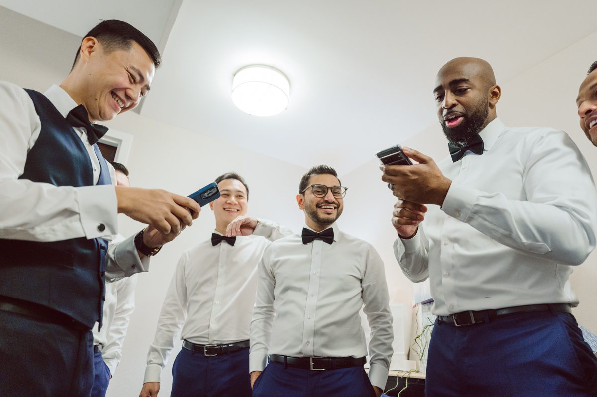 Duffield St, Brooklyn on November 19 even though it's Saturday morning it was still very busy. But luckily I found street parking right on Duffield St in front of Sheraton Downtown Brooklyn which was where I needed to be for Ariana and Jon's wedding prep. Vicky from VickyC5 hair/makeup team was there beautifying the ladies, I went straight to flat lays of Ariana's wedding details such as rings, jewelry and her wedding invitations. I use ribbons, extra loose flowers to make the flat lays more fine art looking. Once all the details are done, my full focus goes to the bride Ariana and her ladies. Ariana and Jon were planning to do a Chinese Door Game at the hotel room, so as soon as Ariana was ready in her Hanbok (Korean Traditional Wedding Outfit) Jon and his groomsmen arrived at the door. With Ariana's bridal suite crowded with too many people Ariana's bridesmaids started to give instructions to the games that Jon and his groomsmen need to play in order to get through the second door so that Jon can meet/see his bride Ariana. While the games are happening outside Ariana's door one of the bridesmaid has her phone on FaceTime so that Ariana can see how the men are doing during all the door games. I of course had my second shooter inside the room with Ariana to get her reactions which was hilarious. After the door games, we then moved to a conference room of at Sheraton Downtown Brooklyn for Ariana and Jon's Chinese Tea Pouring Ceremony (this is Jon's Chinese side's wedding tradition where you pour tea to all the elders in the family). Once all the Chines and Korean wedding traditions are over, we all rushed to Brooklyn Botanical Garden. Traffic from Sheraton Downtown Brooklyn to Brooklyn Botanical Garden was pretty bad, as usual. Once I arrived there of course was no street parking available near the entrance and parking lot for Brooklyn Botanical Garden was way too far for me to carry all the gears. After driving around I found one spot few blocks away from the Brooklyn Botanical Garden entrance. Brooklyn Botanical Garden was busy with Lightscape preparation and installation which we were not allowed to photograph so we were left with very little options for wedding portrait backdrop, plus it was COLD and we were looking light! These are important things to consider when you are planning for Winter wedding. I worked as quickly as possible with Ariana and Jon's first look and bridal party photos. Then we stayed inside for family photos since elders did not wanted to go outside which I totally don't blame. Then I quickly took Ariana and Jon outside for bit more couple's portraits then it was time for the wedding ceremony. Ariana and Jon's wedding ceremony held place at The Palm House at Brooklyn Botanical Garden, but because it was an winter wedding we've lost all the light and I had to use my video lights but over all the ceremony was beautiful and Oh Fleur NYC did absolutely an amazing job with ceremony decor (floral/candles). The Palm House was empty again, OhfleurNYC as well as Brooklyn Botanical Garden staff were busy turning the room. Oh Fleur NYC's Jessica's talent was amazing her usage of floral, choice of colors and mixing the floral with tall candles were magical. Turned The Palm House into a beautiful and romantic garden. Warmth of candles, peach and pinks of flowers all blended so well turning the Palm House at Brooklyn Botanical Garden in to fairytale floral ballroom. Ariana and Jon attended cocktail enjoying their time with friends and family before their wedding reception at The Palm House. Ariana and Jon's wedding at The Palm House at Brooklyn Botanical Garden documented by Karis from Hey Karis New York, Brooklyn, Hudson Valley and Catskills Wedding Photographer and NYC Elopement Photographer.