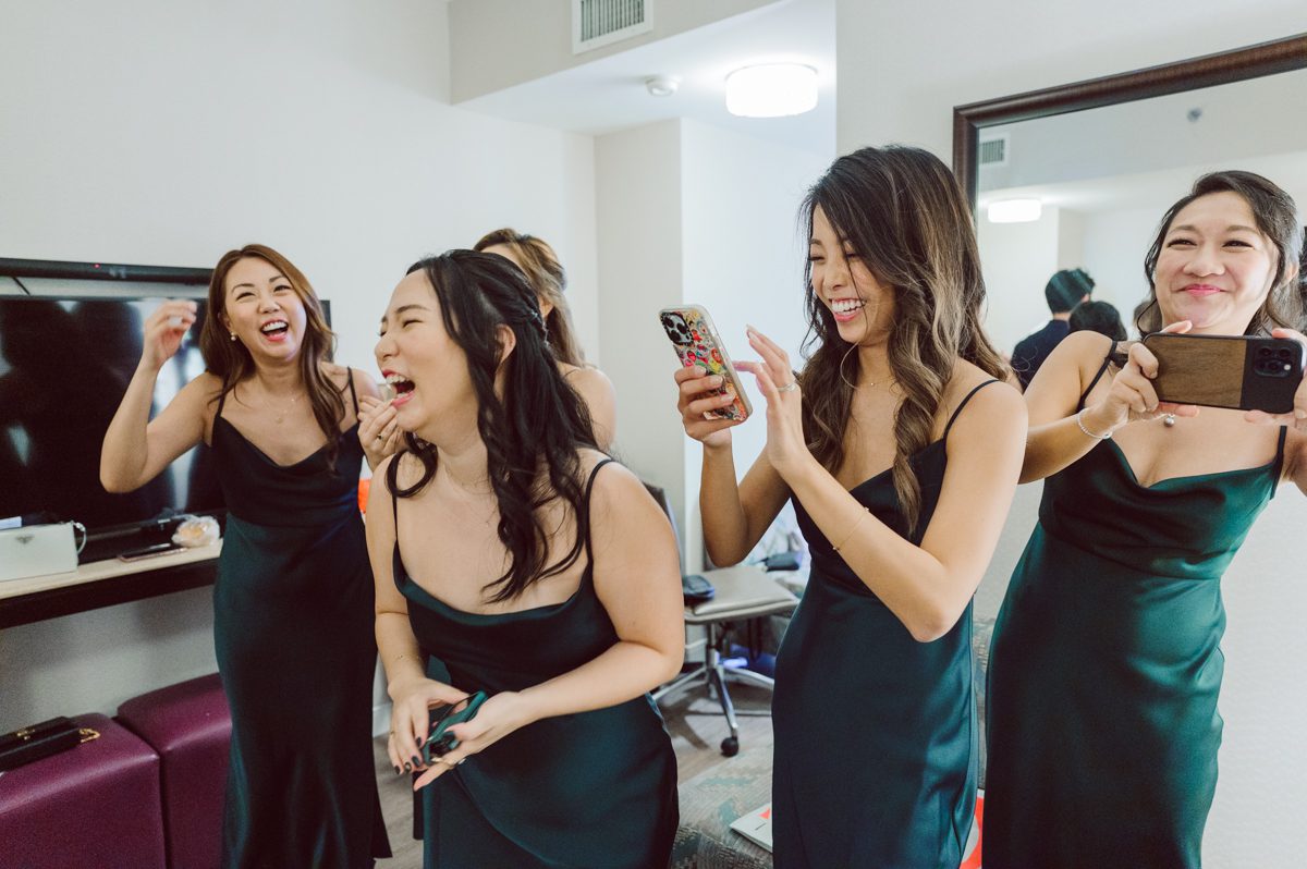 Duffield St, Brooklyn on November 19 even though it's Saturday morning it was still very busy. But luckily I found street parking right on Duffield St in front of Sheraton Downtown Brooklyn which was where I needed to be for Ariana and Jon's wedding prep. Vicky from VickyC5 hair/makeup team was there beautifying the ladies, I went straight to flat lays of Ariana's wedding details such as rings, jewelry and her wedding invitations. I use ribbons, extra loose flowers to make the flat lays more fine art looking. Once all the details are done, my full focus goes to the bride Ariana and her ladies. Ariana and Jon were planning to do a Chinese Door Game at the hotel room, so as soon as Ariana was ready in her Hanbok (Korean Traditional Wedding Outfit) Jon and his groomsmen arrived at the door. With Ariana's bridal suite crowded with too many people Ariana's bridesmaids started to give instructions to the games that Jon and his groomsmen need to play in order to get through the second door so that Jon can meet/see his bride Ariana. While the games are happening outside Ariana's door one of the bridesmaid has her phone on FaceTime so that Ariana can see how the men are doing during all the door games. I of course had my second shooter inside the room with Ariana to get her reactions which was hilarious. After the door games, we then moved to a conference room of at Sheraton Downtown Brooklyn for Ariana and Jon's Chinese Tea Pouring Ceremony (this is Jon's Chinese side's wedding tradition where you pour tea to all the elders in the family). Once all the Chines and Korean wedding traditions are over, we all rushed to Brooklyn Botanical Garden. Traffic from Sheraton Downtown Brooklyn to Brooklyn Botanical Garden was pretty bad, as usual. Once I arrived there of course was no street parking available near the entrance and parking lot for Brooklyn Botanical Garden was way too far for me to carry all the gears. After driving around I found one spot few blocks away from the Brooklyn Botanical Garden entrance. Brooklyn Botanical Garden was busy with Lightscape preparation and installation which we were not allowed to photograph so we were left with very little options for wedding portrait backdrop, plus it was COLD and we were looking light! These are important things to consider when you are planning for Winter wedding. I worked as quickly as possible with Ariana and Jon's first look and bridal party photos. Then we stayed inside for family photos since elders did not wanted to go outside which I totally don't blame. Then I quickly took Ariana and Jon outside for bit more couple's portraits then it was time for the wedding ceremony. Ariana and Jon's wedding ceremony held place at The Palm House at Brooklyn Botanical Garden, but because it was an winter wedding we've lost all the light and I had to use my video lights but over all the ceremony was beautiful and Oh Fleur NYC did absolutely an amazing job with ceremony decor (floral/candles). The Palm House was empty again, OhfleurNYC as well as Brooklyn Botanical Garden staff were busy turning the room. Oh Fleur NYC's Jessica's talent was amazing her usage of floral, choice of colors and mixing the floral with tall candles were magical. Turned The Palm House into a beautiful and romantic garden. Warmth of candles, peach and pinks of flowers all blended so well turning the Palm House at Brooklyn Botanical Garden in to fairytale floral ballroom. Ariana and Jon attended cocktail enjoying their time with friends and family before their wedding reception at The Palm House. Ariana and Jon's wedding at The Palm House at Brooklyn Botanical Garden documented by Karis from Hey Karis New York, Brooklyn, Hudson Valley and Catskills Wedding Photographer and NYC Elopement Photographer.