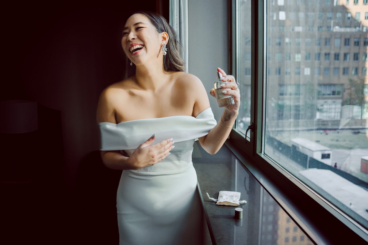 Duffield St, Brooklyn on November 19 even though it's Saturday morning it was still very busy. But luckily I found street parking right on Duffield St in front of Sheraton Downtown Brooklyn which was where I needed to be for Ariana and Jon's wedding prep. Vicky from VickyC5 hair/makeup team was there beautifying the ladies, I went straight to flat lays of Ariana's wedding details such as rings, jewelry and her wedding invitations. I use ribbons, extra loose flowers to make the flat lays more fine art looking. Once all the details are done, my full focus goes to the bride Ariana and her ladies. Ariana and Jon were planning to do a Chinese Door Game at the hotel room, so as soon as Ariana was ready in her Hanbok (Korean Traditional Wedding Outfit) Jon and his groomsmen arrived at the door. With Ariana's bridal suite crowded with too many people Ariana's bridesmaids started to give instructions to the games that Jon and his groomsmen need to play in order to get through the second door so that Jon can meet/see his bride Ariana. While the games are happening outside Ariana's door one of the bridesmaid has her phone on FaceTime so that Ariana can see how the men are doing during all the door games. I of course had my second shooter inside the room with Ariana to get her reactions which was hilarious. After the door games, we then moved to a conference room of at Sheraton Downtown Brooklyn for Ariana and Jon's Chinese Tea Pouring Ceremony (this is Jon's Chinese side's wedding tradition where you pour tea to all the elders in the family). Once all the Chines and Korean wedding traditions are over, we all rushed to Brooklyn Botanical Garden. Traffic from Sheraton Downtown Brooklyn to Brooklyn Botanical Garden was pretty bad, as usual. Once I arrived there of course was no street parking available near the entrance and parking lot for Brooklyn Botanical Garden was way too far for me to carry all the gears. After driving around I found one spot few blocks away from the Brooklyn Botanical Garden entrance. Brooklyn Botanical Garden was busy with Lightscape preparation and installation which we were not allowed to photograph so we were left with very little options for wedding portrait backdrop, plus it was COLD and we were looking light! These are important things to consider when you are planning for Winter wedding. I worked as quickly as possible with Ariana and Jon's first look and bridal party photos. Then we stayed inside for family photos since elders did not wanted to go outside which I totally don't blame. Then I quickly took Ariana and Jon outside for bit more couple's portraits then it was time for the wedding ceremony. Ariana and Jon's wedding ceremony held place at The Palm House at Brooklyn Botanical Garden, but because it was an winter wedding we've lost all the light and I had to use my video lights but over all the ceremony was beautiful and Oh Fleur NYC did absolutely an amazing job with ceremony decor (floral/candles). The Palm House was empty again, OhfleurNYC as well as Brooklyn Botanical Garden staff were busy turning the room. Oh Fleur NYC's Jessica's talent was amazing her usage of floral, choice of colors and mixing the floral with tall candles were magical. Turned The Palm House into a beautiful and romantic garden. Warmth of candles, peach and pinks of flowers all blended so well turning the Palm House at Brooklyn Botanical Garden in to fairytale floral ballroom. Ariana and Jon attended cocktail enjoying their time with friends and family before their wedding reception at The Palm House. Ariana and Jon's wedding at The Palm House at Brooklyn Botanical Garden documented by Karis from Hey Karis New York, Brooklyn, Hudson Valley and Catskills Wedding Photographer and NYC Elopement Photographer.