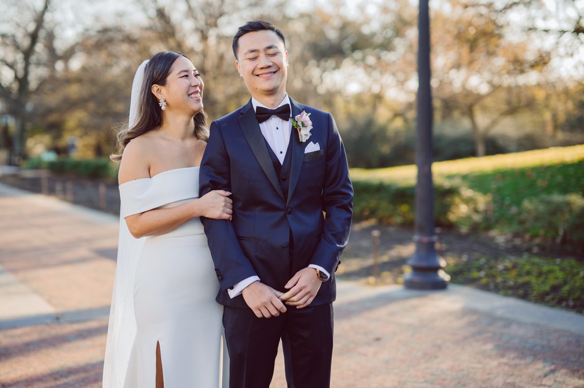 Duffield St, Brooklyn on November 19 even though it's Saturday morning it was still very busy. But luckily I found street parking right on Duffield St in front of Sheraton Downtown Brooklyn which was where I needed to be for Ariana and Jon's wedding prep. Vicky from VickyC5 hair/makeup team was there beautifying the ladies, I went straight to flat lays of Ariana's wedding details such as rings, jewelry and her wedding invitations. I use ribbons, extra loose flowers to make the flat lays more fine art looking. Once all the details are done, my full focus goes to the bride Ariana and her ladies. Ariana and Jon were planning to do a Chinese Door Game at the hotel room, so as soon as Ariana was ready in her Hanbok (Korean Traditional Wedding Outfit) Jon and his groomsmen arrived at the door. With Ariana's bridal suite crowded with too many people Ariana's bridesmaids started to give instructions to the games that Jon and his groomsmen need to play in order to get through the second door so that Jon can meet/see his bride Ariana. While the games are happening outside Ariana's door one of the bridesmaid has her phone on FaceTime so that Ariana can see how the men are doing during all the door games. I of course had my second shooter inside the room with Ariana to get her reactions which was hilarious. After the door games, we then moved to a conference room of at Sheraton Downtown Brooklyn for Ariana and Jon's Chinese Tea Pouring Ceremony (this is Jon's Chinese side's wedding tradition where you pour tea to all the elders in the family). Once all the Chines and Korean wedding traditions are over, we all rushed to Brooklyn Botanical Garden. Traffic from Sheraton Downtown Brooklyn to Brooklyn Botanical Garden was pretty bad, as usual. Once I arrived there of course was no street parking available near the entrance and parking lot for Brooklyn Botanical Garden was way too far for me to carry all the gears. After driving around I found one spot few blocks away from the Brooklyn Botanical Garden entrance. Brooklyn Botanical Garden was busy with Lightscape preparation and installation which we were not allowed to photograph so we were left with very little options for wedding portrait backdrop, plus it was COLD and we were looking light! These are important things to consider when you are planning for Winter wedding. I worked as quickly as possible with Ariana and Jon's first look and bridal party photos. Then we stayed inside for family photos since elders did not wanted to go outside which I totally don't blame. Then I quickly took Ariana and Jon outside for bit more couple's portraits then it was time for the wedding ceremony. Ariana and Jon's wedding ceremony held place at The Palm House at Brooklyn Botanical Garden, but because it was an winter wedding we've lost all the light and I had to use my video lights but over all the ceremony was beautiful and Oh Fleur NYC did absolutely an amazing job with ceremony decor (floral/candles). The Palm House was empty again, OhfleurNYC as well as Brooklyn Botanical Garden staff were busy turning the room. Oh Fleur NYC's Jessica's talent was amazing her usage of floral, choice of colors and mixing the floral with tall candles were magical. Turned The Palm House into a beautiful and romantic garden. Warmth of candles, peach and pinks of flowers all blended so well turning the Palm House at Brooklyn Botanical Garden in to fairytale floral ballroom. Ariana and Jon attended cocktail enjoying their time with friends and family before their wedding reception at The Palm House. Ariana and Jon's wedding at The Palm House at Brooklyn Botanical Garden documented by Karis from Hey Karis New York, Brooklyn, Hudson Valley and Catskills Wedding Photographer and NYC Elopement Photographer.