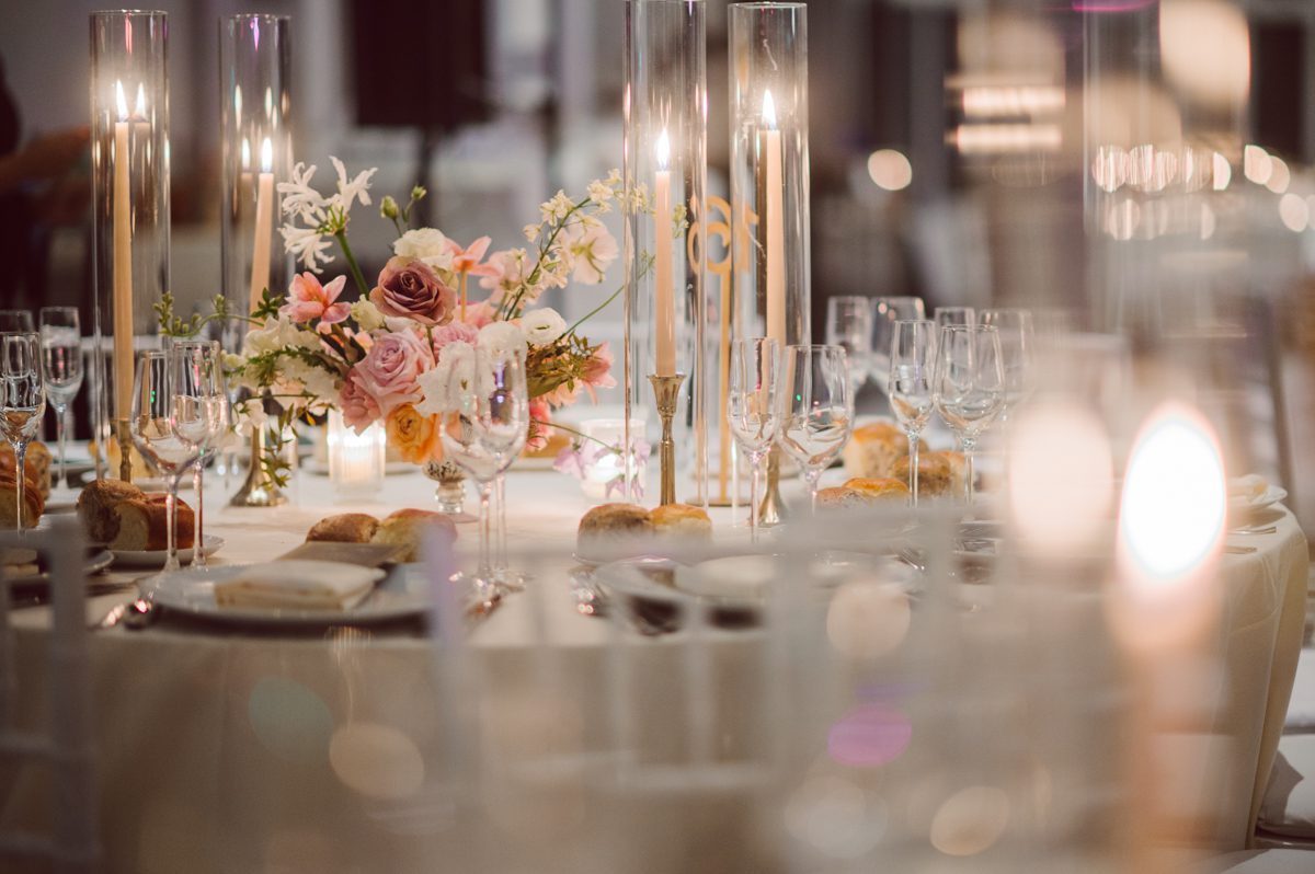 Duffield St, Brooklyn on November 19 even though it's Saturday morning it was still very busy. But luckily I found street parking right on Duffield St in front of Sheraton Downtown Brooklyn which was where I needed to be for Ariana and Jon's wedding prep. Vicky from VickyC5 hair/makeup team was there beautifying the ladies, I went straight to flat lays of Ariana's wedding details such as rings, jewelry and her wedding invitations. I use ribbons, extra loose flowers to make the flat lays more fine art looking. Once all the details are done, my full focus goes to the bride Ariana and her ladies. Ariana and Jon were planning to do a Chinese Door Game at the hotel room, so as soon as Ariana was ready in her Hanbok (Korean Traditional Wedding Outfit) Jon and his groomsmen arrived at the door. With Ariana's bridal suite crowded with too many people Ariana's bridesmaids started to give instructions to the games that Jon and his groomsmen need to play in order to get through the second door so that Jon can meet/see his bride Ariana. While the games are happening outside Ariana's door one of the bridesmaid has her phone on FaceTime so that Ariana can see how the men are doing during all the door games. I of course had my second shooter inside the room with Ariana to get her reactions which was hilarious. After the door games, we then moved to a conference room of at Sheraton Downtown Brooklyn for Ariana and Jon's Chinese Tea Pouring Ceremony (this is Jon's Chinese side's wedding tradition where you pour tea to all the elders in the family). Once all the Chines and Korean wedding traditions are over, we all rushed to Brooklyn Botanical Garden. Traffic from Sheraton Downtown Brooklyn to Brooklyn Botanical Garden was pretty bad, as usual. Once I arrived there of course was no street parking available near the entrance and parking lot for Brooklyn Botanical Garden was way too far for me to carry all the gears. After driving around I found one spot few blocks away from the Brooklyn Botanical Garden entrance. Brooklyn Botanical Garden was busy with Lightscape preparation and installation which we were not allowed to photograph so we were left with very little options for wedding portrait backdrop, plus it was COLD and we were looking light! These are important things to consider when you are planning for Winter wedding. I worked as quickly as possible with Ariana and Jon's first look and bridal party photos. Then we stayed inside for family photos since elders did not wanted to go outside which I totally don't blame. Then I quickly took Ariana and Jon outside for bit more couple's portraits then it was time for the wedding ceremony. Ariana and Jon's wedding ceremony held place at The Palm House at Brooklyn Botanical Garden, but because it was an winter wedding we've lost all the light and I had to use my video lights but over all the ceremony was beautiful and Oh Fleur NYC did absolutely an amazing job with ceremony decor (floral/candles). The Palm House was empty again, OhfleurNYC as well as Brooklyn Botanical Garden staff were busy turning the room. Oh Fleur NYC's Jessica's talent was amazing her usage of floral, choice of colors and mixing the floral with tall candles were magical. Turned The Palm House into a beautiful and romantic garden. Warmth of candles, peach and pinks of flowers all blended so well turning the Palm House at Brooklyn Botanical Garden in to fairytale floral ballroom. Ariana and Jon attended cocktail enjoying their time with friends and family before their wedding reception at The Palm House. Ariana and Jon's wedding at The Palm House at Brooklyn Botanical Garden documented by Karis from Hey Karis New York, Brooklyn, Hudson Valley and Catskills Wedding Photographer and NYC Elopement Photographer.