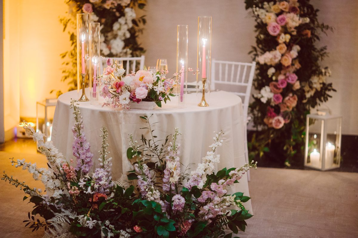 Duffield St, Brooklyn on November 19 even though it's Saturday morning it was still very busy. But luckily I found street parking right on Duffield St in front of Sheraton Downtown Brooklyn which was where I needed to be for Ariana and Jon's wedding prep. Vicky from VickyC5 hair/makeup team was there beautifying the ladies, I went straight to flat lays of Ariana's wedding details such as rings, jewelry and her wedding invitations. I use ribbons, extra loose flowers to make the flat lays more fine art looking. Once all the details are done, my full focus goes to the bride Ariana and her ladies. Ariana and Jon were planning to do a Chinese Door Game at the hotel room, so as soon as Ariana was ready in her Hanbok (Korean Traditional Wedding Outfit) Jon and his groomsmen arrived at the door. With Ariana's bridal suite crowded with too many people Ariana's bridesmaids started to give instructions to the games that Jon and his groomsmen need to play in order to get through the second door so that Jon can meet/see his bride Ariana. While the games are happening outside Ariana's door one of the bridesmaid has her phone on FaceTime so that Ariana can see how the men are doing during all the door games. I of course had my second shooter inside the room with Ariana to get her reactions which was hilarious. After the door games, we then moved to a conference room of at Sheraton Downtown Brooklyn for Ariana and Jon's Chinese Tea Pouring Ceremony (this is Jon's Chinese side's wedding tradition where you pour tea to all the elders in the family). Once all the Chines and Korean wedding traditions are over, we all rushed to Brooklyn Botanical Garden. Traffic from Sheraton Downtown Brooklyn to Brooklyn Botanical Garden was pretty bad, as usual. Once I arrived there of course was no street parking available near the entrance and parking lot for Brooklyn Botanical Garden was way too far for me to carry all the gears. After driving around I found one spot few blocks away from the Brooklyn Botanical Garden entrance. Brooklyn Botanical Garden was busy with Lightscape preparation and installation which we were not allowed to photograph so we were left with very little options for wedding portrait backdrop, plus it was COLD and we were looking light! These are important things to consider when you are planning for Winter wedding. I worked as quickly as possible with Ariana and Jon's first look and bridal party photos. Then we stayed inside for family photos since elders did not wanted to go outside which I totally don't blame. Then I quickly took Ariana and Jon outside for bit more couple's portraits then it was time for the wedding ceremony. Ariana and Jon's wedding ceremony held place at The Palm House at Brooklyn Botanical Garden, but because it was an winter wedding we've lost all the light and I had to use my video lights but over all the ceremony was beautiful and Oh Fleur NYC did absolutely an amazing job with ceremony decor (floral/candles). The Palm House was empty again, OhfleurNYC as well as Brooklyn Botanical Garden staff were busy turning the room. Oh Fleur NYC's Jessica's talent was amazing her usage of floral, choice of colors and mixing the floral with tall candles were magical. Turned The Palm House into a beautiful and romantic garden. Warmth of candles, peach and pinks of flowers all blended so well turning the Palm House at Brooklyn Botanical Garden in to fairytale floral ballroom. Ariana and Jon attended cocktail enjoying their time with friends and family before their wedding reception at The Palm House. Ariana and Jon's wedding at The Palm House at Brooklyn Botanical Garden documented by Karis from Hey Karis New York, Brooklyn, Hudson Valley and Catskills Wedding Photographer and NYC Elopement Photographer.