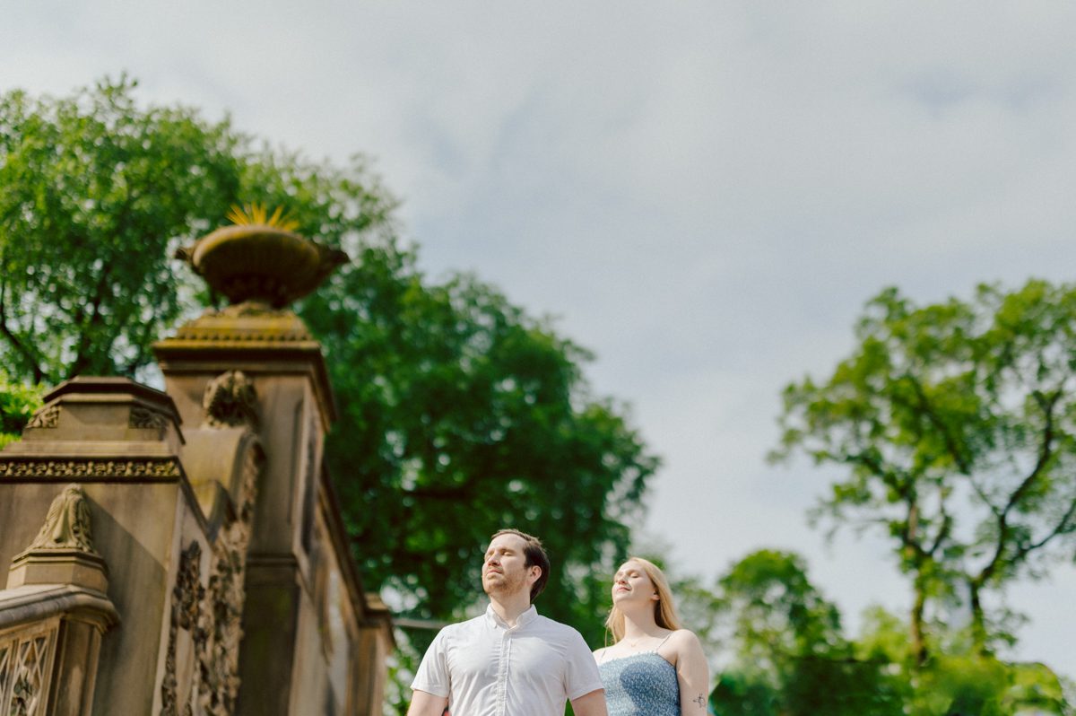 Off leash hour has officially started at Bethesda Fountain in Central Park NY, which is really the best time to go to Bethesda Fountain but only if you are a dog lover! There will be all kind of different personalities of dogs running wild around Bethesda Fountain off leash having the best time of their lives and I can sit there watching these adorable creatures all day long! But today I was there to photograph Katie and Craig and needed to stay focused. Katie and Craig were absolutely the best humans and fellow animal/nature lovers like me so we walked around and may have gotten lost in the woody forest of Central Park but this Central Park engagement session was bit different because Katie and Craig wanted to focus on the nature so we went looking for the lush greens and florals of Central Park. Bethesda Fountain Central Park NY engagement session documented by by Karis | Hey Karis | Catskills, Hudson Valley NY, elopement and wedding photographer | Brooklyn NY elopement and wedding photographer | Manhattan NY elopement and wedding photographer | Hey Karis is fun documentary wedding and elopement photographer.
