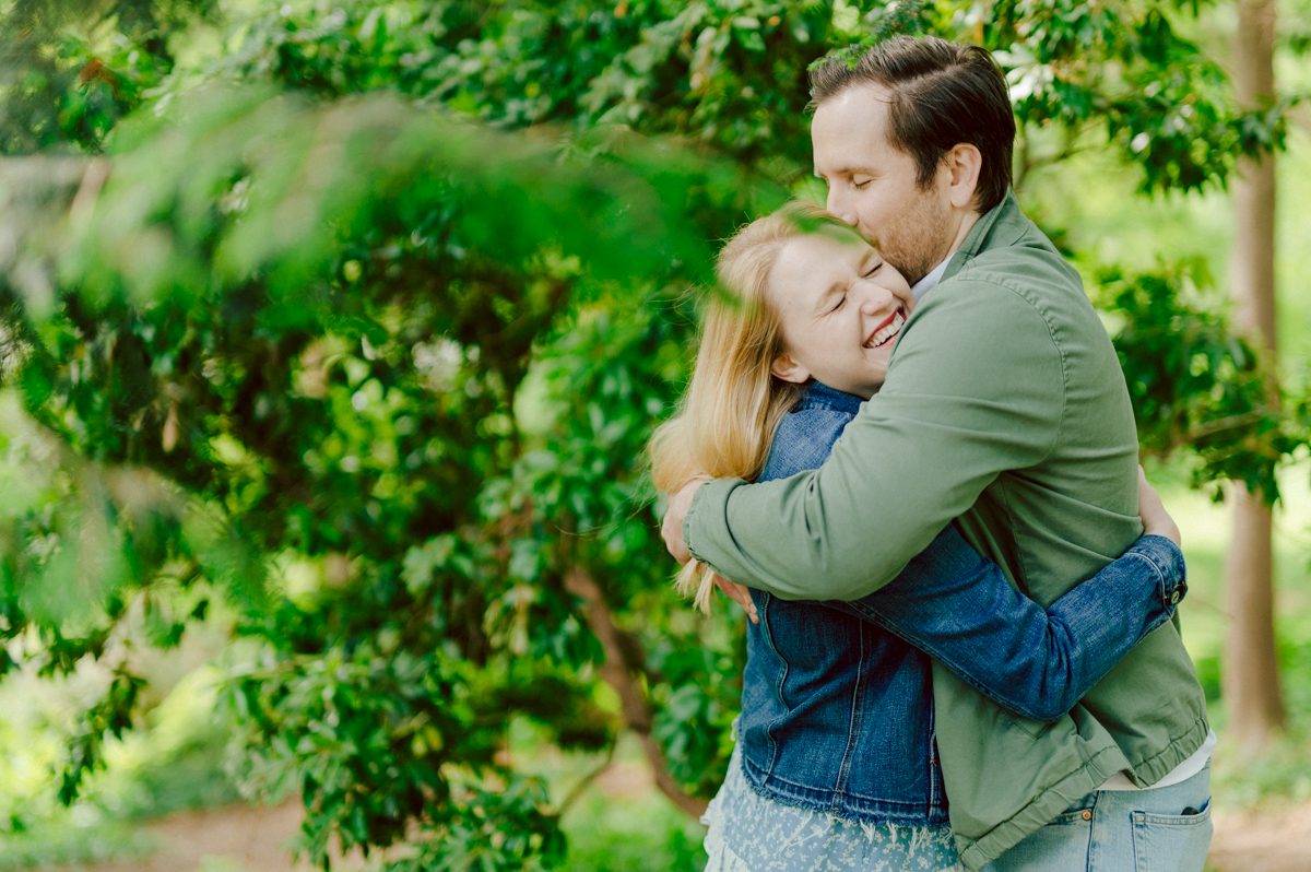 Off leash hour has officially started at Bethesda Fountain in Central Park NY, which is really the best time to go to Bethesda Fountain but only if you are a dog lover! There will be all kind of different personalities of dogs running wild around Bethesda Fountain off leash having the best time of their lives and I can sit there watching these adorable creatures all day long! But today I was there to photograph Katie and Craig and needed to stay focused. Katie and Craig were absolutely the best humans and fellow animal/nature lovers like me so we walked around and may have gotten lost in the woody forest of Central Park but this Central Park engagement session was bit different because Katie and Craig wanted to focus on the nature so we went looking for the lush greens and florals of Central Park. Bethesda Fountain Central Park NY engagement session documented by by Karis | Hey Karis | Catskills, Hudson Valley NY, elopement and wedding photographer | Brooklyn NY elopement and wedding photographer | Manhattan NY elopement and wedding photographer | Hey Karis is fun documentary wedding and elopement photographer.