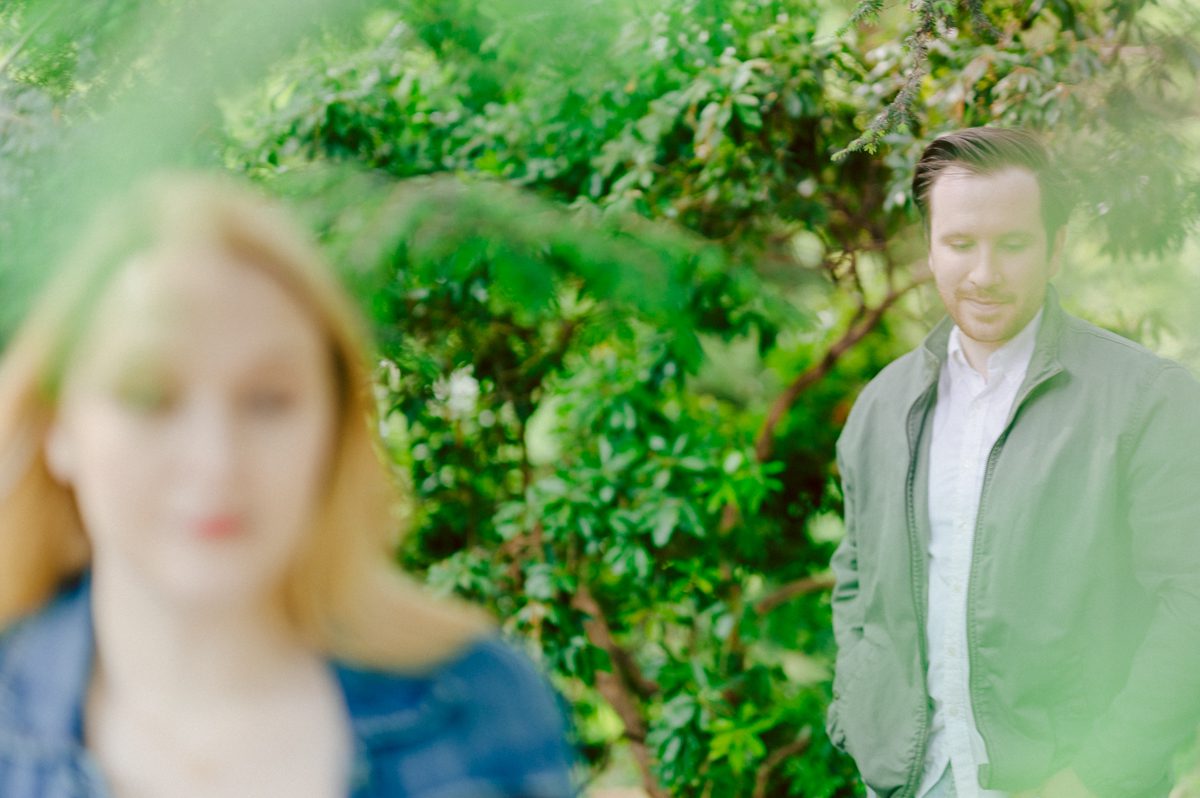 Off leash hour has officially started at Bethesda Fountain in Central Park NY, which is really the best time to go to Bethesda Fountain but only if you are a dog lover! There will be all kind of different personalities of dogs running wild around Bethesda Fountain off leash having the best time of their lives and I can sit there watching these adorable creatures all day long! But today I was there to photograph Katie and Craig and needed to stay focused. Katie and Craig were absolutely the best humans and fellow animal/nature lovers like me so we walked around and may have gotten lost in the woody forest of Central Park but this Central Park engagement session was bit different because Katie and Craig wanted to focus on the nature so we went looking for the lush greens and florals of Central Park. Bethesda Fountain Central Park NY engagement session documented by by Karis | Hey Karis | Catskills, Hudson Valley NY, elopement and wedding photographer | Brooklyn NY elopement and wedding photographer | Manhattan NY elopement and wedding photographer | Hey Karis is fun documentary wedding and elopement photographer.