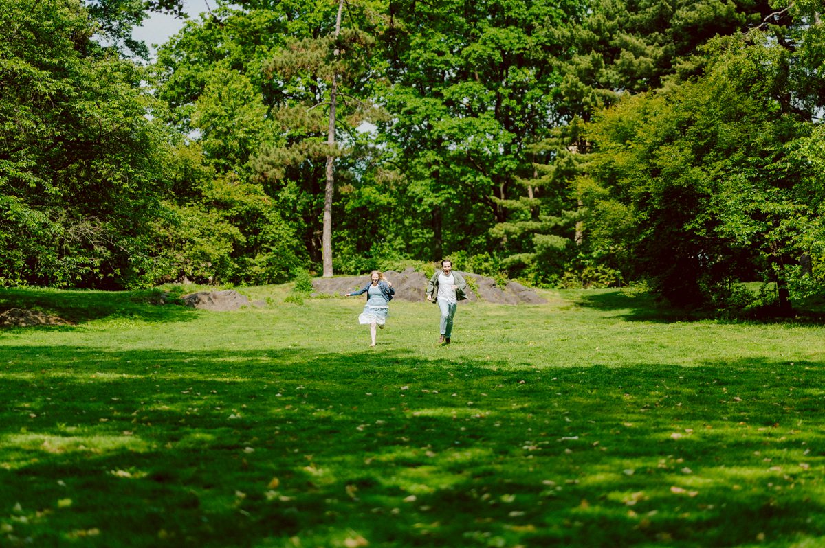Off leash hour has officially started at Bethesda Fountain in Central Park NY, which is really the best time to go to Bethesda Fountain but only if you are a dog lover! There will be all kind of different personalities of dogs running wild around Bethesda Fountain off leash having the best time of their lives and I can sit there watching these adorable creatures all day long! But today I was there to photograph Katie and Craig and needed to stay focused. Katie and Craig were absolutely the best humans and fellow animal/nature lovers like me so we walked around and may have gotten lost in the woody forest of Central Park but this Central Park engagement session was bit different because Katie and Craig wanted to focus on the nature so we went looking for the lush greens and florals of Central Park. Bethesda Fountain Central Park NY engagement session documented by by Karis | Hey Karis | Catskills, Hudson Valley NY, elopement and wedding photographer | Brooklyn NY elopement and wedding photographer | Manhattan NY elopement and wedding photographer | Hey Karis is fun documentary wedding and elopement photographer.