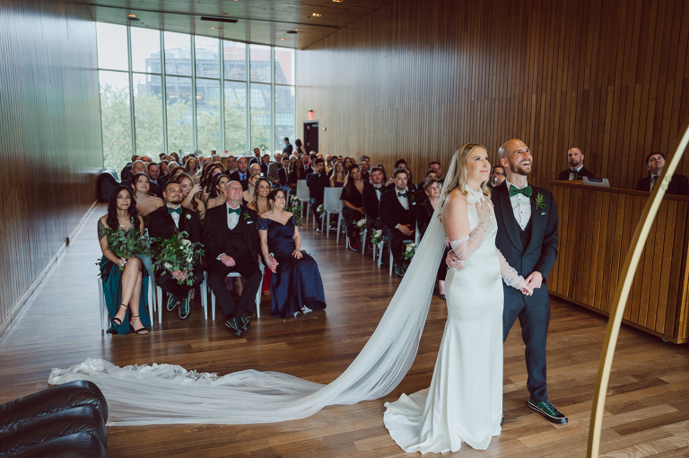 I've photographed multiple of Chris' best friends weddings several years ago. One couple at Tribeca Rooftop NY, another couple at Oheka Castle NY and few other friends at Long Island. So Chris knew when he was going to get married he would hire me. Few years later I get an email from Chris regarding his wedding. These are my dream ideal clients, because they know they will be hiring me even before they meet with me! After a quick phone call, Kaci and Chris booked and their engagement session date was set. We went to Orchard St in NYC where they used to live, walked around their old neighborhood while getting some engagement pics. Kaci and Chris' wedding at The Standard High Line, NY on April 22, 2023. It was raining for the whole week prior to Kaci and Chris wedding day making me bit worried but rain stopped on the morning of Kaci and Chris' wedding at The Standard High Line, NY. Kaci and Chris each got their own hotel rooms to get ready. With quite a big bridal party 10 bridesmaids and 10 groomsmen Kaci and Chris popped champagne bottles. With champagne glasses in their hands Kaci and her brides people laughed as they got their MUAH done by Face Time Beauty at The Standard High Line, NY. And Chris along with his groomsmen got ready in their very retro "Mad Men" vibe room fooling and goofing around till the ceremony at The Standard High Line, NY. Kaci and Chris wedding was held at The High Line Room and Terrace which overlooks The High Line, NY. Weather was gorgeous and I was excited to take Kaci and Chris to The High Line for their wedding portraits but unfortunately during their wedding ceremony at The High Line Room it started pouring! They say it's good luck when it rains on your wedding day, right! Unfortunately, going to The High Line for photos was no go, so backup was at The Terrace where the cocktail hour was going on and which was not even that big of a space. But with help of everyone I managed to get 22 people group photo done on The Terrace while the cocktail hour was going on and all the family formal photos as well as all the bridal party pairs. with only few minutes till Kaci and Chris' wedding reception at The High Line Room, we went up to The Top of Standard for Kaci and Chris' wedding portraits. Working super fast I managed to get good enough amount of wedding portraits of just Kaci and Chris. Music by Jack from LJDJ was playing, Kaci and Chris' wedding reception at The High Line Room at The Standard Hotel High Line NY was about to begin. Kaci and Chris' wedding reception at The Standard High Line was on fire from start to the last second of the evening. It was pouring outside, young people didn't seem to care it was raining and congregated the streets of Meatpacking District while I was weaving through the crowd of party goers to get home as quickly as possible. The night was just starting for them and I was ready for bed. Kaci and Chris' The High Line Room and Terrace, The Standard High Line, NY wedding documented by by Karis | Hey Karis | Catskills, Hudson Valley NY, elopement and wedding photographer | Brooklyn NY elopement and wedding photographer | Manhattan NY elopement and wedding photographer | Hey Karis is fun documentary wedding and elopement photographer.
