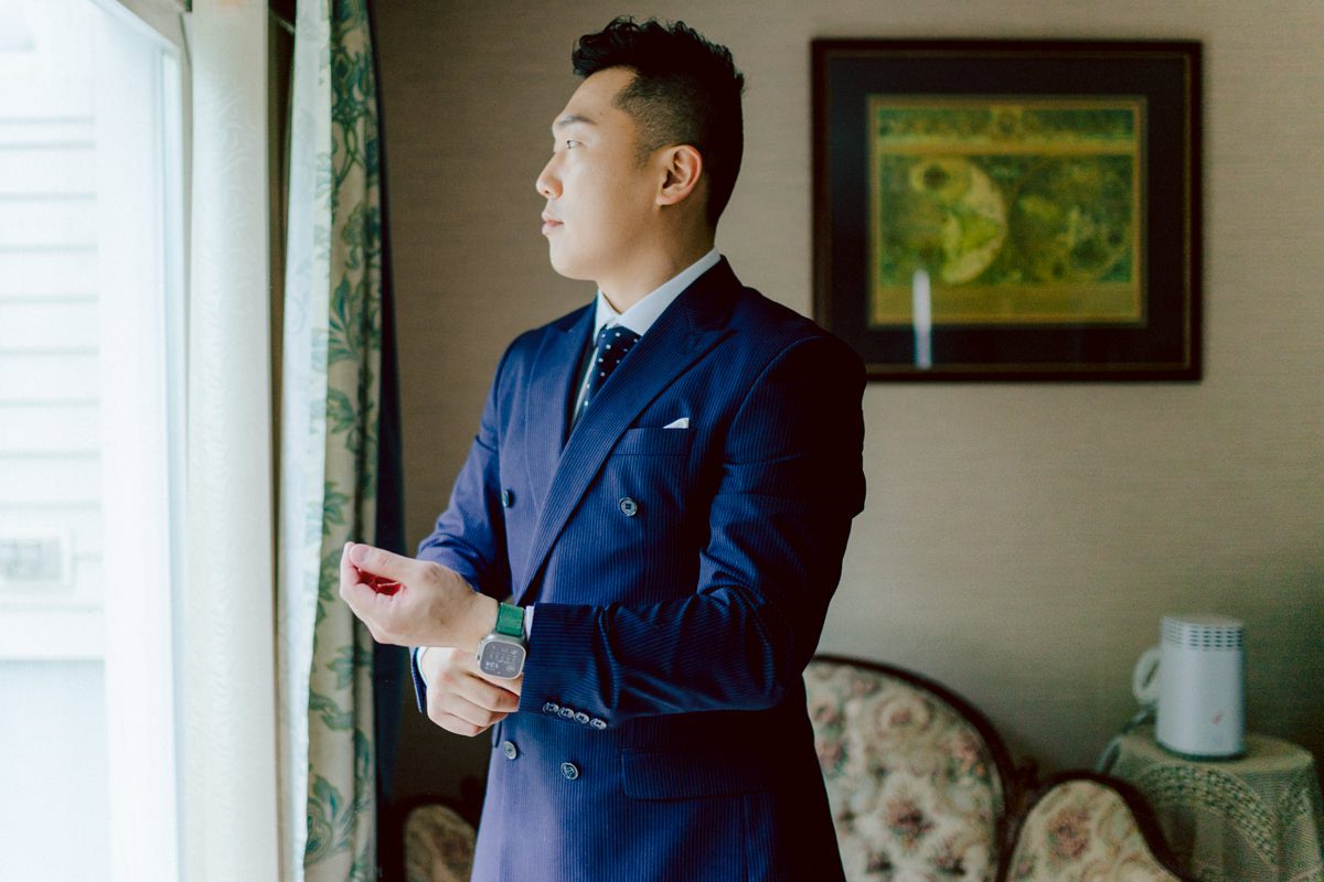 Chloe and Bosco are one of the sweetest couple!!! Well mannered, kind, sweet, considerate so I was extra excited for Chloe and Bosco's wedding at The Chart House. Chloe and Bosco both got ready at Chole's parents house in Oradell NJ where both sets of parents were all gathered. With no bridal party Chloe and Bosco had a quiet wedding morning. Midway through the morning prep, it started raining outside and did not look like we will be going outside for photos anytime soon or even till evening at Weehawken. With wishful mind of clear sky later, we got photos with family, parents and the couple at Chole's parent's house before leaving for Chloe and Bosco's wedding ceremony at St. Michaels Church in Fort Lee, NJ. St. Michales Church is small cute Korean Catholic church in Fort Lee, NJ where Chloe and Bosco belongs to. We can hear the rain falling down harder while getting group and family formal photos at St. Michaels Church before heading to Chart House in Weehawken NJ for Chloe and Bosco's intimate wedding reception. By the time we were in the car to drive over to Chart House, it was POURING. Chart House was busy with weekend customers enjoying the restaurant and they had three events going on upstairs! The entrance to Chart House was crowded with people coming and leaving waiting for the valet to bring their cars. Chloe and Bosco with help of their friends DIYed lots of wedding decor, music and games/entertainment during their wedding reception at Chart House. My heart really belongs to these small and intimate weddings where the couple focuses on them and what is really important to them instead of a big wedding celebration to show off of copy what they saw on social media. Sweet and lovely intimate wedding of Chloe and Bosco at Chart House Weehawken NJ wedding documented by by Karis | Hey Karis | Catskills, Hudson Valley NY elopement and wedding photographer | Brooklyn NY elopement and wedding photographer | Manhattan NY elopement and wedding photographer | Hey Karis is fun documentary wedding and elopement photographer.
