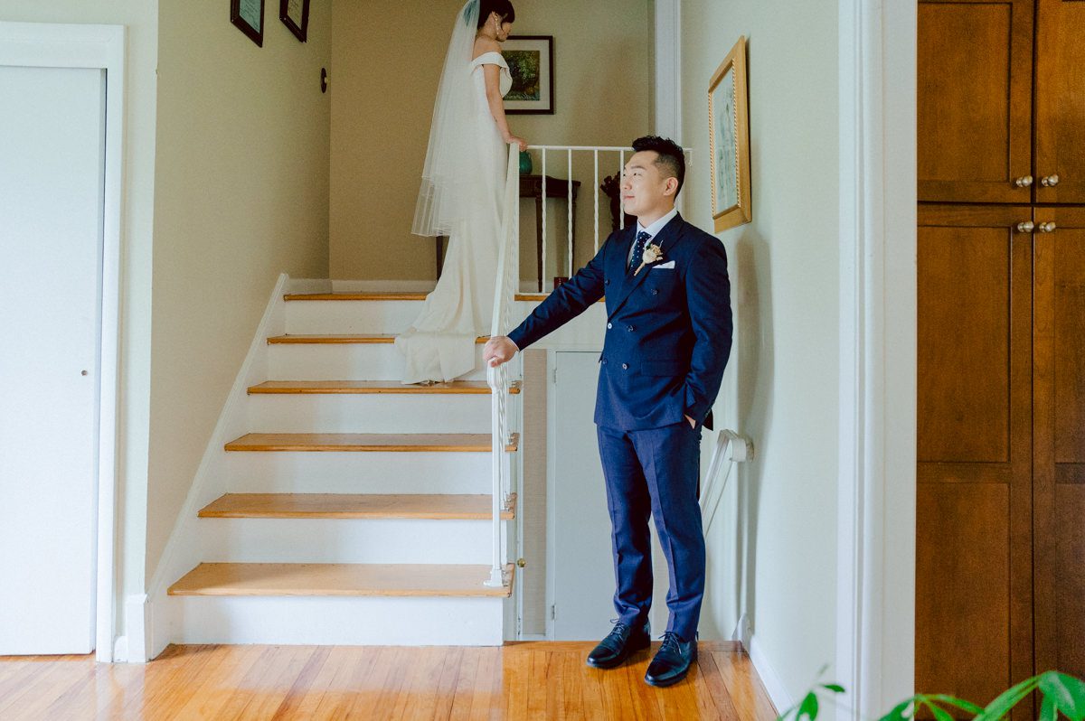 Chloe and Bosco are one of the sweetest couple!!! Well mannered, kind, sweet, considerate so I was extra excited for Chloe and Bosco's wedding at The Chart House. Chloe and Bosco both got ready at Chole's parents house in Oradell NJ where both sets of parents were all gathered. With no bridal party Chloe and Bosco had a quiet wedding morning. Midway through the morning prep, it started raining outside and did not look like we will be going outside for photos anytime soon or even till evening at Weehawken. With wishful mind of clear sky later, we got photos with family, parents and the couple at Chole's parent's house before leaving for Chloe and Bosco's wedding ceremony at St. Michaels Church in Fort Lee, NJ. St. Michales Church is small cute Korean Catholic church in Fort Lee, NJ where Chloe and Bosco belongs to. We can hear the rain falling down harder while getting group and family formal photos at St. Michaels Church before heading to Chart House in Weehawken NJ for Chloe and Bosco's intimate wedding reception. By the time we were in the car to drive over to Chart House, it was POURING. Chart House was busy with weekend customers enjoying the restaurant and they had three events going on upstairs! The entrance to Chart House was crowded with people coming and leaving waiting for the valet to bring their cars. Chloe and Bosco with help of their friends DIYed lots of wedding decor, music and games/entertainment during their wedding reception at Chart House. My heart really belongs to these small and intimate weddings where the couple focuses on them and what is really important to them instead of a big wedding celebration to show off of copy what they saw on social media. Sweet and lovely intimate wedding of Chloe and Bosco at Chart House Weehawken NJ wedding documented by by Karis | Hey Karis | Catskills, Hudson Valley NY elopement and wedding photographer | Brooklyn NY elopement and wedding photographer | Manhattan NY elopement and wedding photographer | Hey Karis is fun documentary wedding and elopement photographer.
