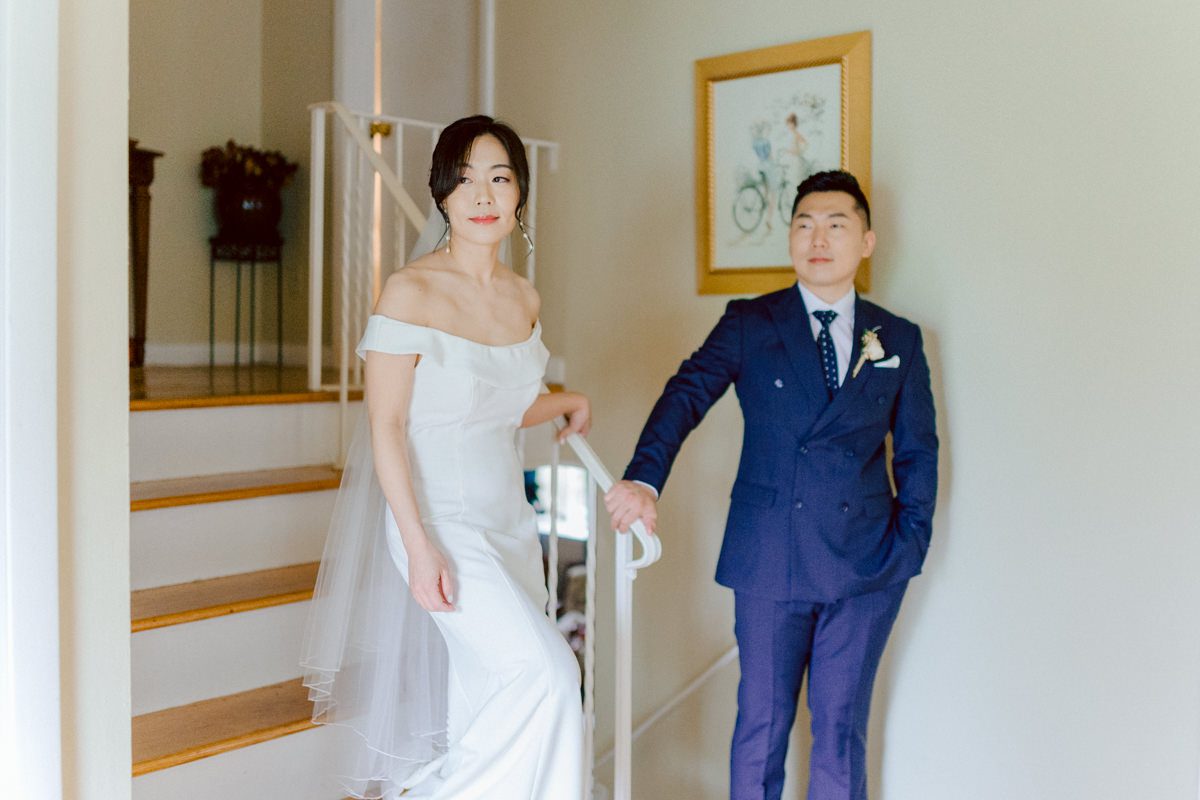 Chloe and Bosco are one of the sweetest couple!!! Well mannered, kind, sweet, considerate so I was extra excited for Chloe and Bosco's wedding at The Chart House. Chloe and Bosco both got ready at Chole's parents house in Oradell NJ where both sets of parents were all gathered. With no bridal party Chloe and Bosco had a quiet wedding morning. Midway through the morning prep, it started raining outside and did not look like we will be going outside for photos anytime soon or even till evening at Weehawken. With wishful mind of clear sky later, we got photos with family, parents and the couple at Chole's parent's house before leaving for Chloe and Bosco's wedding ceremony at St. Michaels Church in Fort Lee, NJ. St. Michales Church is small cute Korean Catholic church in Fort Lee, NJ where Chloe and Bosco belongs to. We can hear the rain falling down harder while getting group and family formal photos at St. Michaels Church before heading to Chart House in Weehawken NJ for Chloe and Bosco's intimate wedding reception. By the time we were in the car to drive over to Chart House, it was POURING. Chart House was busy with weekend customers enjoying the restaurant and they had three events going on upstairs! The entrance to Chart House was crowded with people coming and leaving waiting for the valet to bring their cars. Chloe and Bosco with help of their friends DIYed lots of wedding decor, music and games/entertainment during their wedding reception at Chart House. My heart really belongs to these small and intimate weddings where the couple focuses on them and what is really important to them instead of a big wedding celebration to show off of copy what they saw on social media. Sweet and lovely intimate wedding of Chloe and Bosco at Chart House Weehawken NJ wedding documented by by Karis | Hey Karis | Catskills, Hudson Valley NY elopement and wedding photographer | Brooklyn NY elopement and wedding photographer | Manhattan NY elopement and wedding photographer | Hey Karis is fun documentary wedding and elopement photographer.
