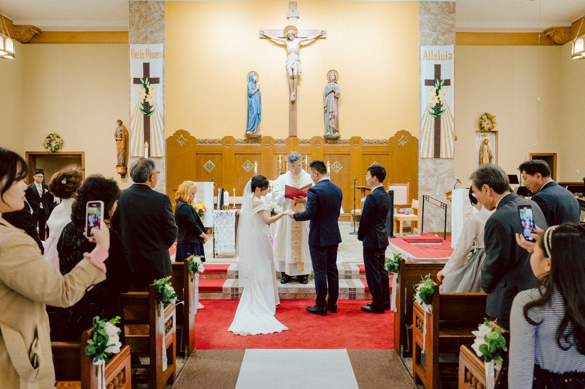 Chloe and Bosco are one of the sweetest couple!!! Well mannered, kind, sweet, considerate so I was extra excited for Chloe and Bosco's wedding at The Chart House. Chloe and Bosco both got ready at Chole's parents house in Oradell NJ where both sets of parents were all gathered. With no bridal party Chloe and Bosco had a quiet wedding morning. Midway through the morning prep, it started raining outside and did not look like we will be going outside for photos anytime soon or even till evening at Weehawken. With wishful mind of clear sky later, we got photos with family, parents and the couple at Chole's parent's house before leaving for Chloe and Bosco's wedding ceremony at St. Michaels Church in Fort Lee, NJ. St. Michales Church is small cute Korean Catholic church in Fort Lee, NJ where Chloe and Bosco belongs to. We can hear the rain falling down harder while getting group and family formal photos at St. Michaels Church before heading to Chart House in Weehawken NJ for Chloe and Bosco's intimate wedding reception. By the time we were in the car to drive over to Chart House, it was POURING. Chart House was busy with weekend customers enjoying the restaurant and they had three events going on upstairs! The entrance to Chart House was crowded with people coming and leaving waiting for the valet to bring their cars. Chloe and Bosco with help of their friends DIYed lots of wedding decor, music and games/entertainment during their wedding reception at Chart House. My heart really belongs to these small and intimate weddings where the couple focuses on them and what is really important to them instead of a big wedding celebration to show off of copy what they saw on social media. Sweet and lovely intimate wedding of Chloe and Bosco at Chart House Weehawken NJ wedding documented by by Karis | Hey Karis | Catskills, Hudson Valley NY elopement and wedding photographer | Brooklyn NY elopement and wedding photographer | Manhattan NY elopement and wedding photographer | Hey Karis is fun documentary wedding and elopement photographer.
