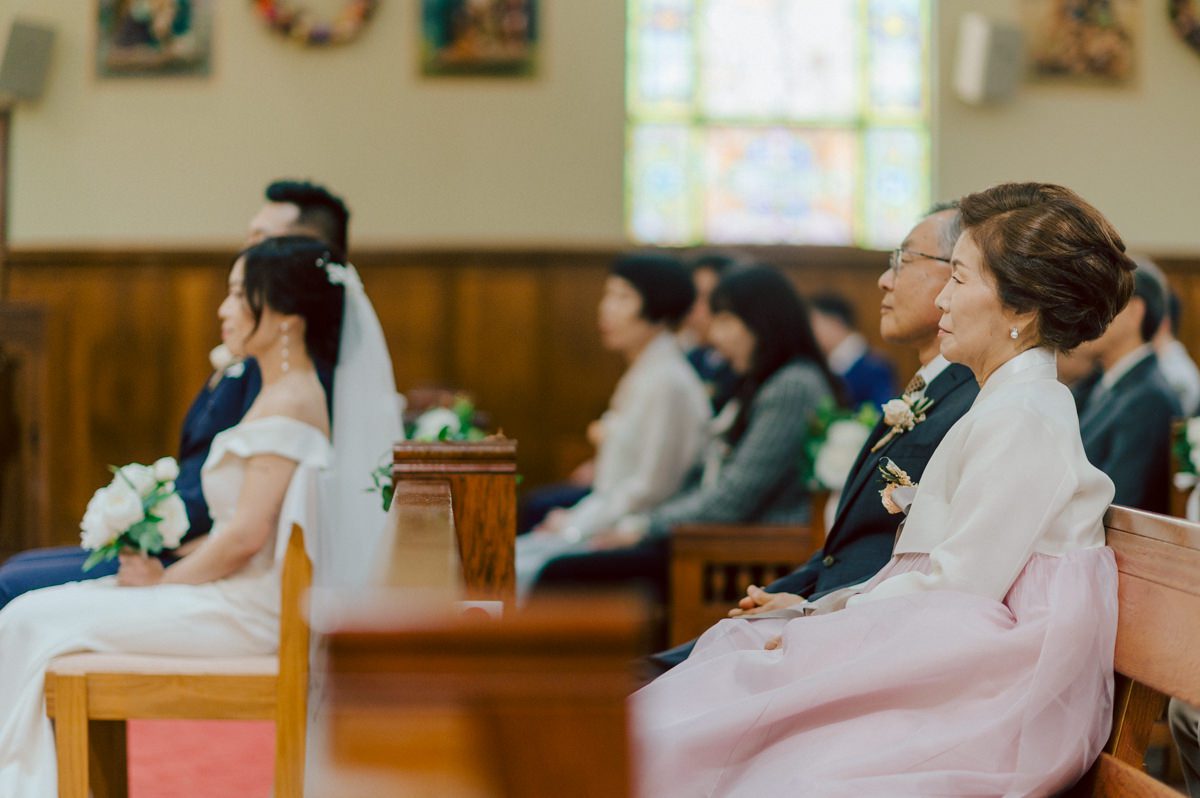 Chloe and Bosco are one of the sweetest couple!!! Well mannered, kind, sweet, considerate so I was extra excited for Chloe and Bosco's wedding at The Chart House. Chloe and Bosco both got ready at Chole's parents house in Oradell NJ where both sets of parents were all gathered. With no bridal party Chloe and Bosco had a quiet wedding morning. Midway through the morning prep, it started raining outside and did not look like we will be going outside for photos anytime soon or even till evening at Weehawken. With wishful mind of clear sky later, we got photos with family, parents and the couple at Chole's parent's house before leaving for Chloe and Bosco's wedding ceremony at St. Michaels Church in Fort Lee, NJ. St. Michales Church is small cute Korean Catholic church in Fort Lee, NJ where Chloe and Bosco belongs to. We can hear the rain falling down harder while getting group and family formal photos at St. Michaels Church before heading to Chart House in Weehawken NJ for Chloe and Bosco's intimate wedding reception. By the time we were in the car to drive over to Chart House, it was POURING. Chart House was busy with weekend customers enjoying the restaurant and they had three events going on upstairs! The entrance to Chart House was crowded with people coming and leaving waiting for the valet to bring their cars. Chloe and Bosco with help of their friends DIYed lots of wedding decor, music and games/entertainment during their wedding reception at Chart House. My heart really belongs to these small and intimate weddings where the couple focuses on them and what is really important to them instead of a big wedding celebration to show off of copy what they saw on social media. Sweet and lovely intimate wedding of Chloe and Bosco at Chart House Weehawken NJ wedding documented by by Karis | Hey Karis | Catskills, Hudson Valley NY elopement and wedding photographer | Brooklyn NY elopement and wedding photographer | Manhattan NY elopement and wedding photographer | Hey Karis is fun documentary wedding and elopement photographer.
