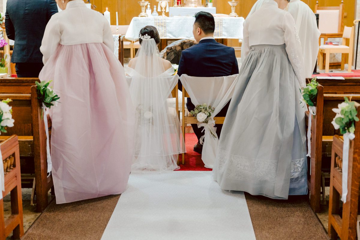 Chloe and Bosco are one of the sweetest couple!!! Well mannered, kind, sweet, considerate so I was extra excited for Chloe and Bosco's wedding at The Chart House. Chloe and Bosco both got ready at Chole's parents house in Oradell NJ where both sets of parents were all gathered. With no bridal party Chloe and Bosco had a quiet wedding morning. Midway through the morning prep, it started raining outside and did not look like we will be going outside for photos anytime soon or even till evening at Weehawken. With wishful mind of clear sky later, we got photos with family, parents and the couple at Chole's parent's house before leaving for Chloe and Bosco's wedding ceremony at St. Michaels Church in Fort Lee, NJ. St. Michales Church is small cute Korean Catholic church in Fort Lee, NJ where Chloe and Bosco belongs to. We can hear the rain falling down harder while getting group and family formal photos at St. Michaels Church before heading to Chart House in Weehawken NJ for Chloe and Bosco's intimate wedding reception. By the time we were in the car to drive over to Chart House, it was POURING. Chart House was busy with weekend customers enjoying the restaurant and they had three events going on upstairs! The entrance to Chart House was crowded with people coming and leaving waiting for the valet to bring their cars. Chloe and Bosco with help of their friends DIYed lots of wedding decor, music and games/entertainment during their wedding reception at Chart House. My heart really belongs to these small and intimate weddings where the couple focuses on them and what is really important to them instead of a big wedding celebration to show off of copy what they saw on social media. Sweet and lovely intimate wedding of Chloe and Bosco at Chart House Weehawken NJ wedding documented by by Karis | Hey Karis | Catskills, Hudson Valley NY elopement and wedding photographer | Brooklyn NY elopement and wedding photographer | Manhattan NY elopement and wedding photographer | Hey Karis is fun documentary wedding and elopement photographer.
