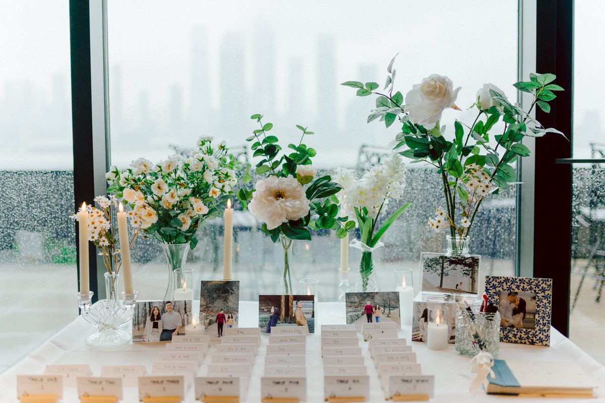 Chloe and Bosco are one of the sweetest couple!!! Well mannered, kind, sweet, considerate so I was extra excited for Chloe and Bosco's wedding at The Chart House. Chloe and Bosco both got ready at Chole's parents house in Oradell NJ where both sets of parents were all gathered. With no bridal party Chloe and Bosco had a quiet wedding morning. Midway through the morning prep, it started raining outside and did not look like we will be going outside for photos anytime soon or even till evening at Weehawken. With wishful mind of clear sky later, we got photos with family, parents and the couple at Chole's parent's house before leaving for Chloe and Bosco's wedding ceremony at St. Michaels Church in Fort Lee, NJ. St. Michales Church is small cute Korean Catholic church in Fort Lee, NJ where Chloe and Bosco belongs to. We can hear the rain falling down harder while getting group and family formal photos at St. Michaels Church before heading to Chart House in Weehawken NJ for Chloe and Bosco's intimate wedding reception. By the time we were in the car to drive over to Chart House, it was POURING. Chart House was busy with weekend customers enjoying the restaurant and they had three events going on upstairs! The entrance to Chart House was crowded with people coming and leaving waiting for the valet to bring their cars. Chloe and Bosco with help of their friends DIYed lots of wedding decor, music and games/entertainment during their wedding reception at Chart House. My heart really belongs to these small and intimate weddings where the couple focuses on them and what is really important to them instead of a big wedding celebration to show off of copy what they saw on social media. Sweet and lovely intimate wedding of Chloe and Bosco at Chart House Weehawken NJ wedding documented by by Karis | Hey Karis | Catskills, Hudson Valley NY elopement and wedding photographer | Brooklyn NY elopement and wedding photographer | Manhattan NY elopement and wedding photographer | Hey Karis is fun documentary wedding and elopement photographer.
