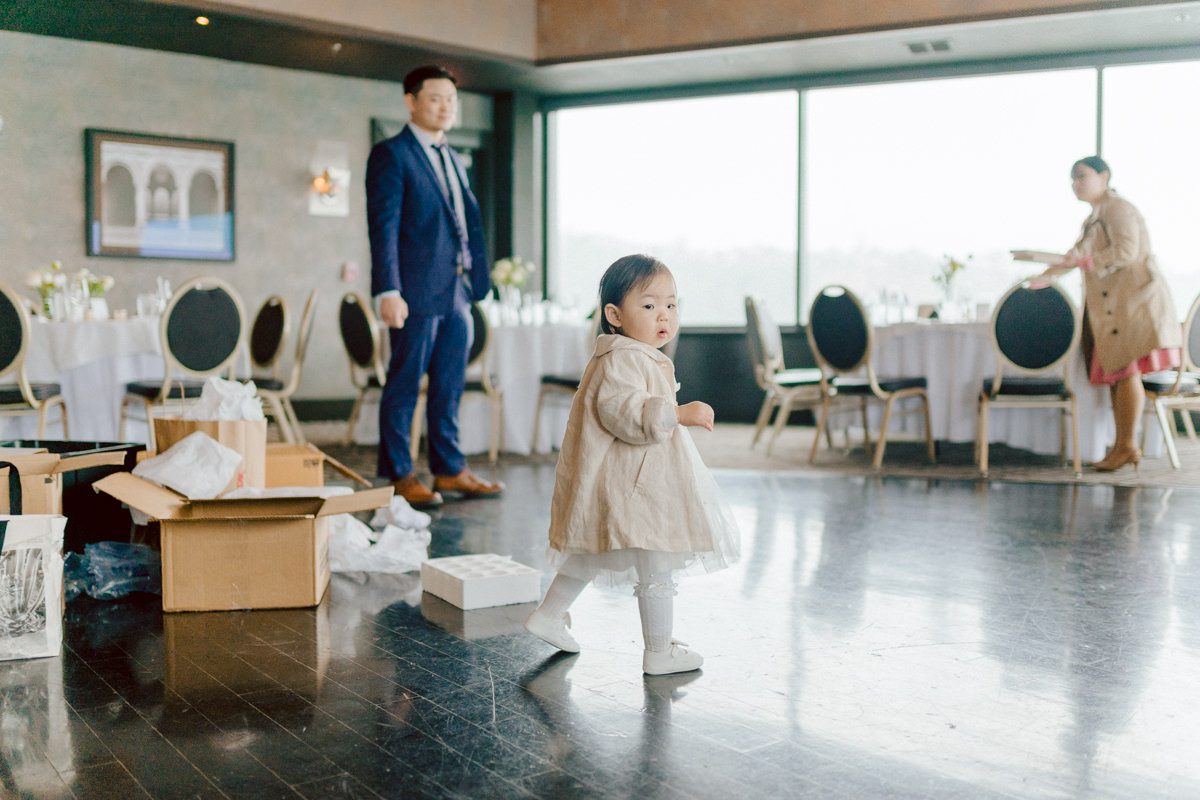 Chloe and Bosco are one of the sweetest couple!!! Well mannered, kind, sweet, considerate so I was extra excited for Chloe and Bosco's wedding at The Chart House. Chloe and Bosco both got ready at Chole's parents house in Oradell NJ where both sets of parents were all gathered. With no bridal party Chloe and Bosco had a quiet wedding morning. Midway through the morning prep, it started raining outside and did not look like we will be going outside for photos anytime soon or even till evening at Weehawken. With wishful mind of clear sky later, we got photos with family, parents and the couple at Chole's parent's house before leaving for Chloe and Bosco's wedding ceremony at St. Michaels Church in Fort Lee, NJ. St. Michales Church is small cute Korean Catholic church in Fort Lee, NJ where Chloe and Bosco belongs to. We can hear the rain falling down harder while getting group and family formal photos at St. Michaels Church before heading to Chart House in Weehawken NJ for Chloe and Bosco's intimate wedding reception. By the time we were in the car to drive over to Chart House, it was POURING. Chart House was busy with weekend customers enjoying the restaurant and they had three events going on upstairs! The entrance to Chart House was crowded with people coming and leaving waiting for the valet to bring their cars. Chloe and Bosco with help of their friends DIYed lots of wedding decor, music and games/entertainment during their wedding reception at Chart House. My heart really belongs to these small and intimate weddings where the couple focuses on them and what is really important to them instead of a big wedding celebration to show off of copy what they saw on social media. Sweet and lovely intimate wedding of Chloe and Bosco at Chart House Weehawken NJ wedding documented by by Karis | Hey Karis | Catskills, Hudson Valley NY elopement and wedding photographer | Brooklyn NY elopement and wedding photographer | Manhattan NY elopement and wedding photographer | Hey Karis is fun documentary wedding and elopement photographer.
