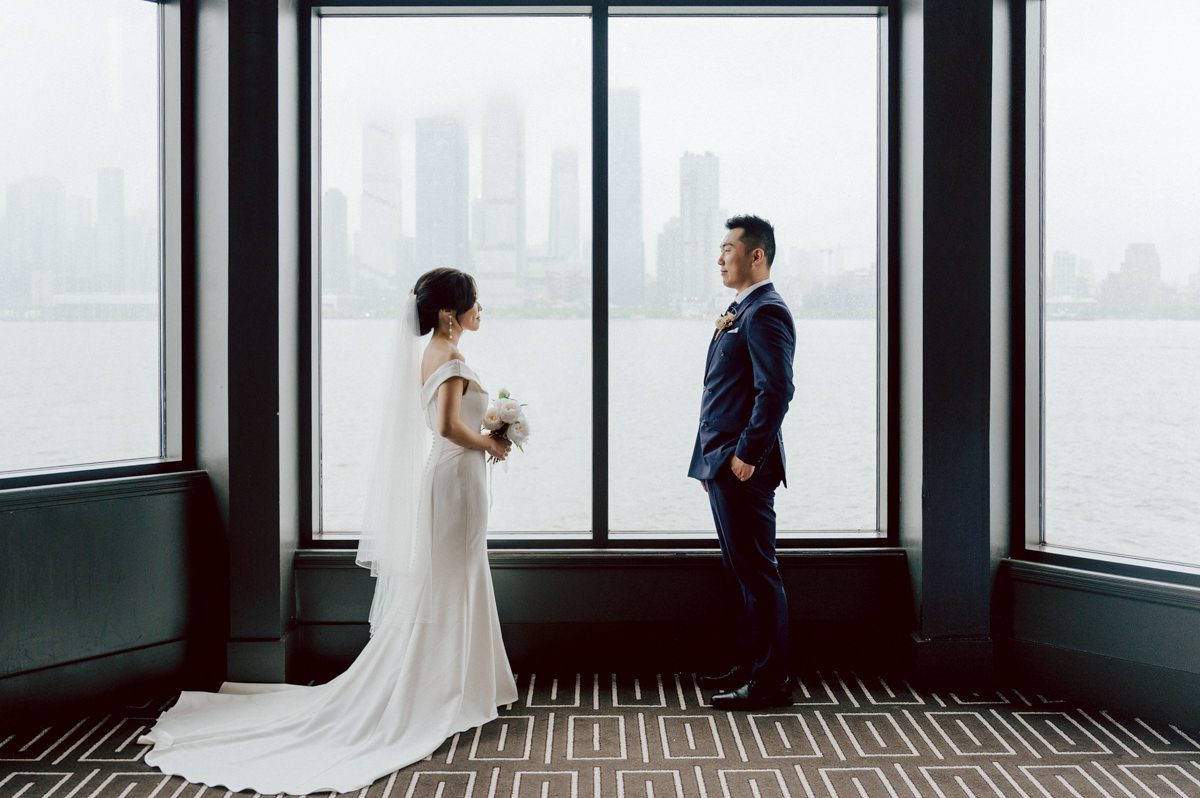 Chloe and Bosco are one of the sweetest couple!!! Well mannered, kind, sweet, considerate so I was extra excited for Chloe and Bosco's wedding at The Chart House. Chloe and Bosco both got ready at Chole's parents house in Oradell NJ where both sets of parents were all gathered. With no bridal party Chloe and Bosco had a quiet wedding morning. Midway through the morning prep, it started raining outside and did not look like we will be going outside for photos anytime soon or even till evening at Weehawken. With wishful mind of clear sky later, we got photos with family, parents and the couple at Chole's parent's house before leaving for Chloe and Bosco's wedding ceremony at St. Michaels Church in Fort Lee, NJ. St. Michales Church is small cute Korean Catholic church in Fort Lee, NJ where Chloe and Bosco belongs to. We can hear the rain falling down harder while getting group and family formal photos at St. Michaels Church before heading to Chart House in Weehawken NJ for Chloe and Bosco's intimate wedding reception. By the time we were in the car to drive over to Chart House, it was POURING. Chart House was busy with weekend customers enjoying the restaurant and they had three events going on upstairs! The entrance to Chart House was crowded with people coming and leaving waiting for the valet to bring their cars. Chloe and Bosco with help of their friends DIYed lots of wedding decor, music and games/entertainment during their wedding reception at Chart House. My heart really belongs to these small and intimate weddings where the couple focuses on them and what is really important to them instead of a big wedding celebration to show off of copy what they saw on social media. Sweet and lovely intimate wedding of Chloe and Bosco at Chart House Weehawken NJ wedding documented by by Karis | Hey Karis | Catskills, Hudson Valley NY elopement and wedding photographer | Brooklyn NY elopement and wedding photographer | Manhattan NY elopement and wedding photographer | Hey Karis is fun documentary wedding and elopement photographer.
