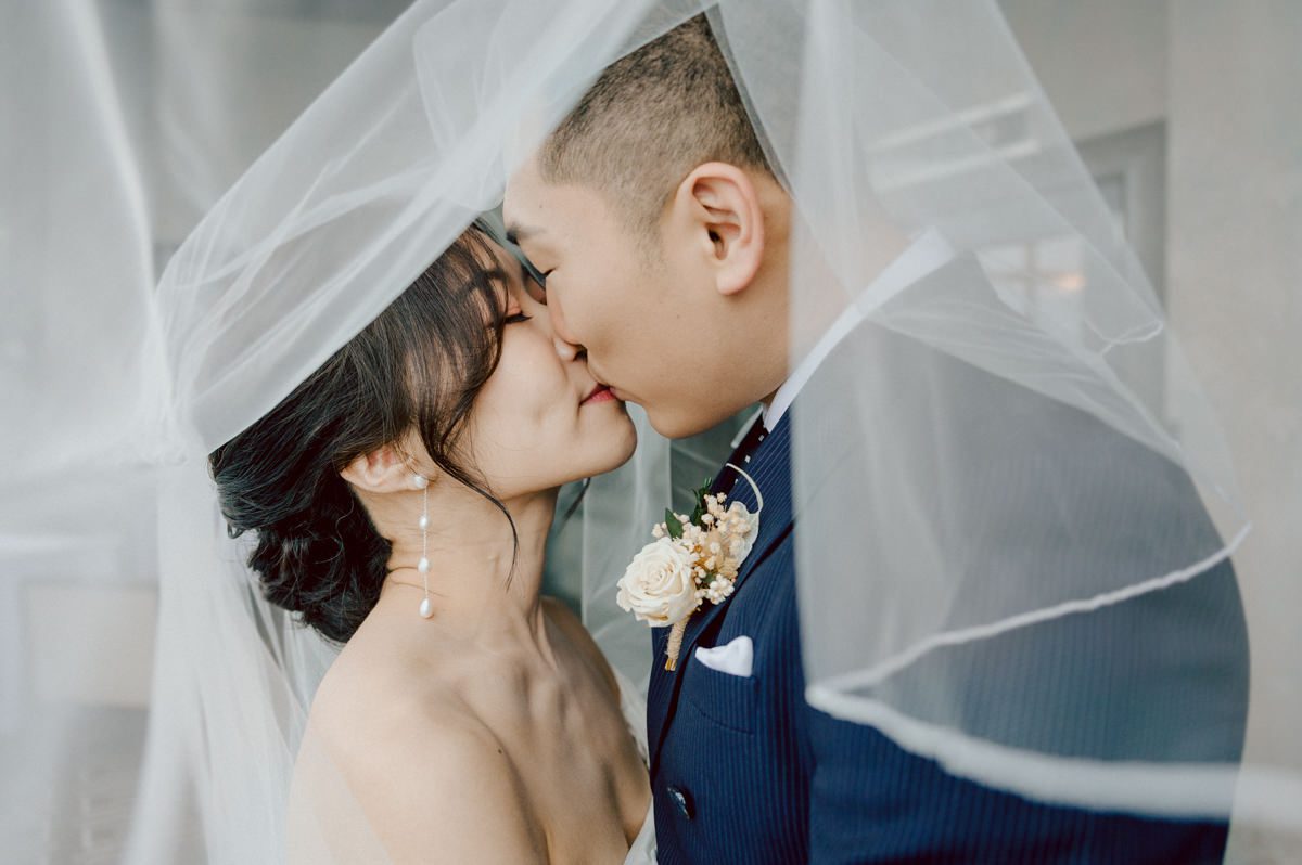 Chloe and Bosco are one of the sweetest couple!!! Well mannered, kind, sweet, considerate so I was extra excited for Chloe and Bosco's wedding at The Chart House. Chloe and Bosco both got ready at Chole's parents house in Oradell NJ where both sets of parents were all gathered. With no bridal party Chloe and Bosco had a quiet wedding morning. Midway through the morning prep, it started raining outside and did not look like we will be going outside for photos anytime soon or even till evening at Weehawken. With wishful mind of clear sky later, we got photos with family, parents and the couple at Chole's parent's house before leaving for Chloe and Bosco's wedding ceremony at St. Michaels Church in Fort Lee, NJ. St. Michales Church is small cute Korean Catholic church in Fort Lee, NJ where Chloe and Bosco belongs to. We can hear the rain falling down harder while getting group and family formal photos at St. Michaels Church before heading to Chart House in Weehawken NJ for Chloe and Bosco's intimate wedding reception. By the time we were in the car to drive over to Chart House, it was POURING. Chart House was busy with weekend customers enjoying the restaurant and they had three events going on upstairs! The entrance to Chart House was crowded with people coming and leaving waiting for the valet to bring their cars. Chloe and Bosco with help of their friends DIYed lots of wedding decor, music and games/entertainment during their wedding reception at Chart House. My heart really belongs to these small and intimate weddings where the couple focuses on them and what is really important to them instead of a big wedding celebration to show off of copy what they saw on social media. Sweet and lovely intimate wedding of Chloe and Bosco at Chart House Weehawken NJ wedding documented by by Karis | Hey Karis | Catskills, Hudson Valley NY elopement and wedding photographer | Brooklyn NY elopement and wedding photographer | Manhattan NY elopement and wedding photographer | Hey Karis is fun documentary wedding and elopement photographer.
