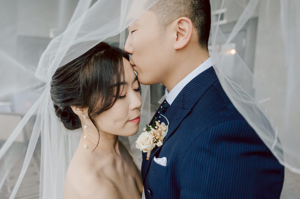 Chloe and Bosco are one of the sweetest couple!!! Well mannered, kind, sweet, considerate so I was extra excited for Chloe and Bosco's wedding at The Chart House. Chloe and Bosco both got ready at Chole's parents house in Oradell NJ where both sets of parents were all gathered. With no bridal party Chloe and Bosco had a quiet wedding morning. Midway through the morning prep, it started raining outside and did not look like we will be going outside for photos anytime soon or even till evening at Weehawken. With wishful mind of clear sky later, we got photos with family, parents and the couple at Chole's parent's house before leaving for Chloe and Bosco's wedding ceremony at St. Michaels Church in Fort Lee, NJ. St. Michales Church is small cute Korean Catholic church in Fort Lee, NJ where Chloe and Bosco belongs to. We can hear the rain falling down harder while getting group and family formal photos at St. Michaels Church before heading to Chart House in Weehawken NJ for Chloe and Bosco's intimate wedding reception. By the time we were in the car to drive over to Chart House, it was POURING. Chart House was busy with weekend customers enjoying the restaurant and they had three events going on upstairs! The entrance to Chart House was crowded with people coming and leaving waiting for the valet to bring their cars. Chloe and Bosco with help of their friends DIYed lots of wedding decor, music and games/entertainment during their wedding reception at Chart House. My heart really belongs to these small and intimate weddings where the couple focuses on them and what is really important to them instead of a big wedding celebration to show off of copy what they saw on social media. Sweet and lovely intimate wedding of Chloe and Bosco at Chart House Weehawken NJ wedding documented by by Karis | Hey Karis | Catskills, Hudson Valley NY elopement and wedding photographer | Brooklyn NY elopement and wedding photographer | Manhattan NY elopement and wedding photographer | Hey Karis is fun documentary wedding and elopement photographer.
