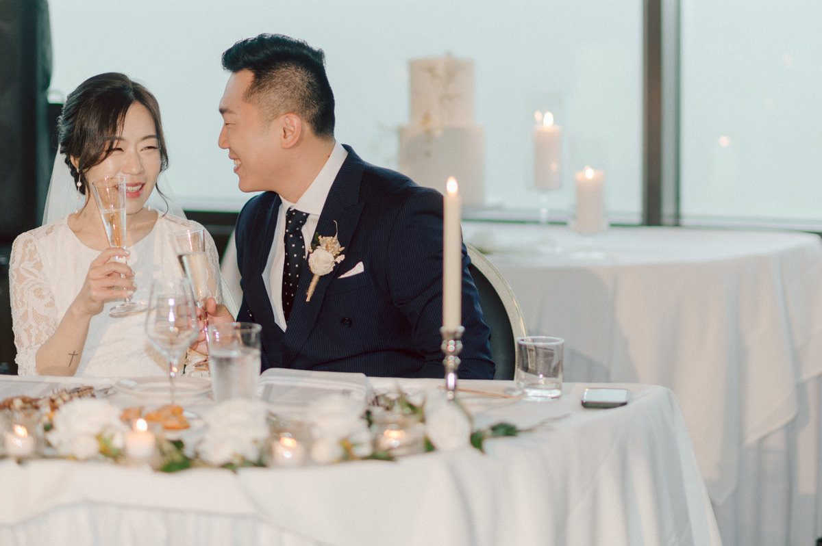 Chloe and Bosco are one of the sweetest couple!!! Well mannered, kind, sweet, considerate so I was extra excited for Chloe and Bosco's wedding at The Chart House. Chloe and Bosco both got ready at Chole's parents house in Oradell NJ where both sets of parents were all gathered. With no bridal party Chloe and Bosco had a quiet wedding morning. Midway through the morning prep, it started raining outside and did not look like we will be going outside for photos anytime soon or even till evening at Weehawken. With wishful mind of clear sky later, we got photos with family, parents and the couple at Chole's parent's house before leaving for Chloe and Bosco's wedding ceremony at St. Michaels Church in Fort Lee, NJ. St. Michales Church is small cute Korean Catholic church in Fort Lee, NJ where Chloe and Bosco belongs to. We can hear the rain falling down harder while getting group and family formal photos at St. Michaels Church before heading to Chart House in Weehawken NJ for Chloe and Bosco's intimate wedding reception. By the time we were in the car to drive over to Chart House, it was POURING. Chart House was busy with weekend customers enjoying the restaurant and they had three events going on upstairs! The entrance to Chart House was crowded with people coming and leaving waiting for the valet to bring their cars. Chloe and Bosco with help of their friends DIYed lots of wedding decor, music and games/entertainment during their wedding reception at Chart House. My heart really belongs to these small and intimate weddings where the couple focuses on them and what is really important to them instead of a big wedding celebration to show off of copy what they saw on social media. Sweet and lovely intimate wedding of Chloe and Bosco at Chart House Weehawken NJ wedding documented by by Karis | Hey Karis | Catskills, Hudson Valley NY elopement and wedding photographer | Brooklyn NY elopement and wedding photographer | Manhattan NY elopement and wedding photographer | Hey Karis is fun documentary wedding and elopement photographer.
